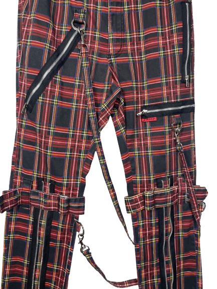 Red and black plaid cargo pants with multiple black zippers, straps, and metal hardware, shown against a plain white background.