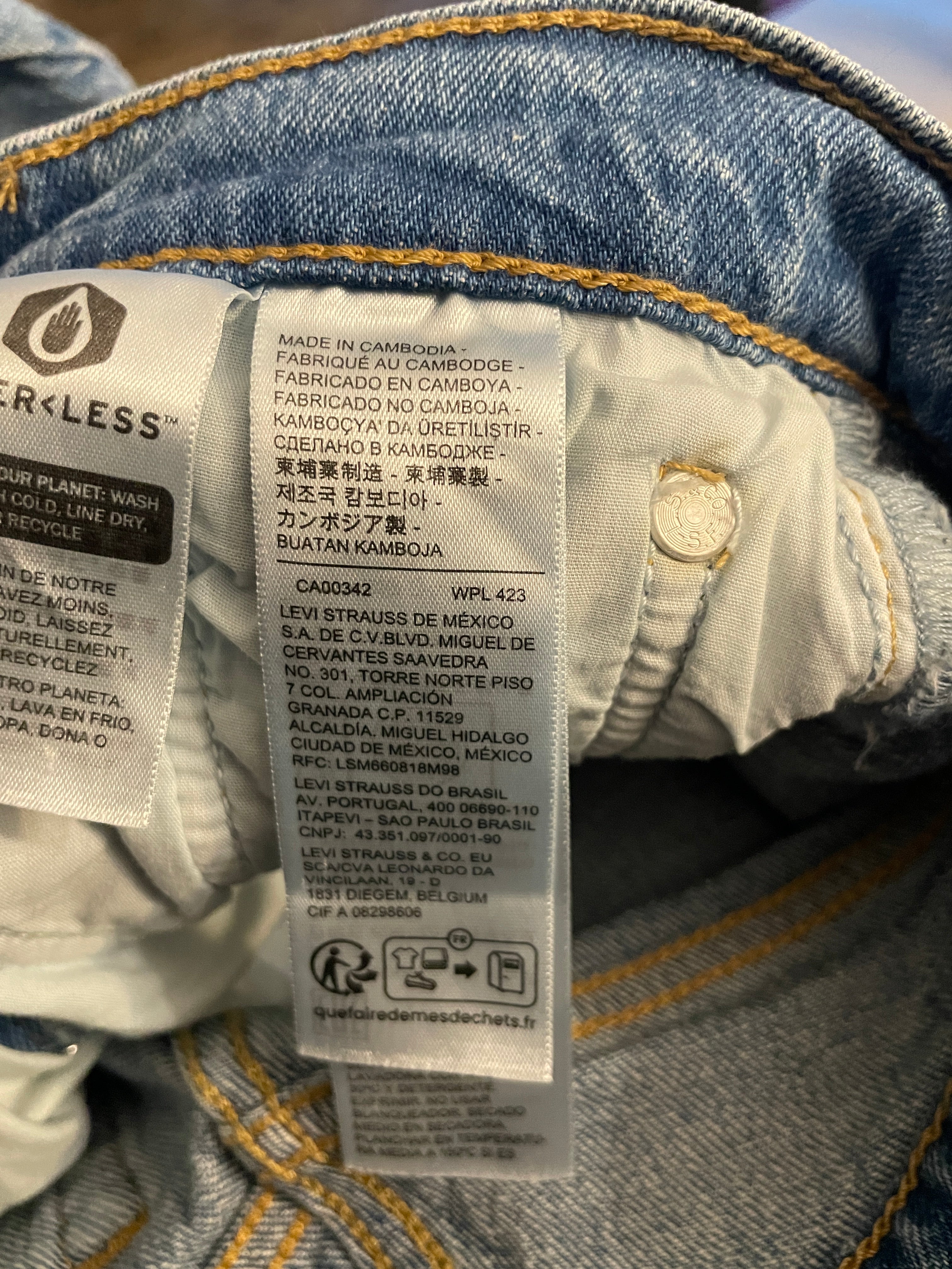 Close-up of the inner neck label of a Levi's denim garment, showing the brand name, country of origin, care instructions, and a metal button.