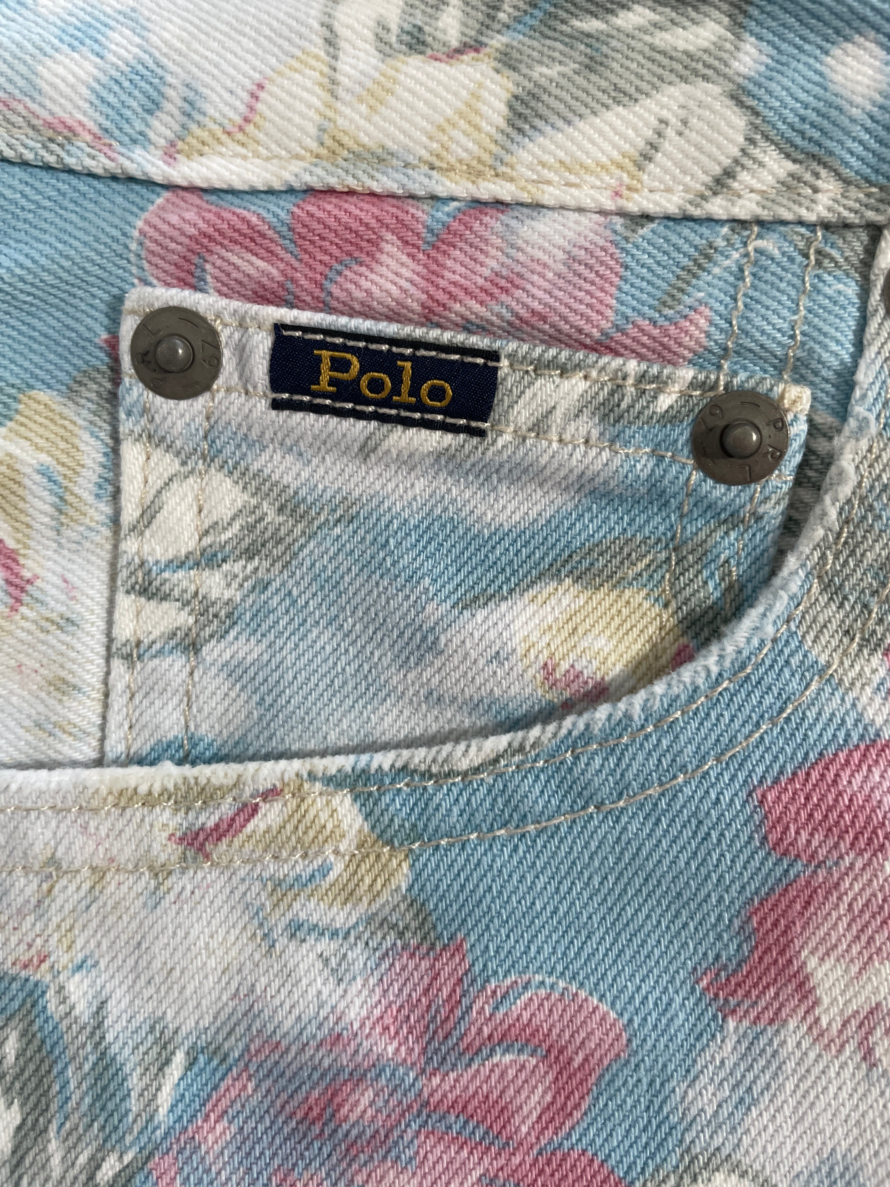 Close-up of a floral denim pocket with metal snap buttons and a visible Polo Ralph Lauren brand label.