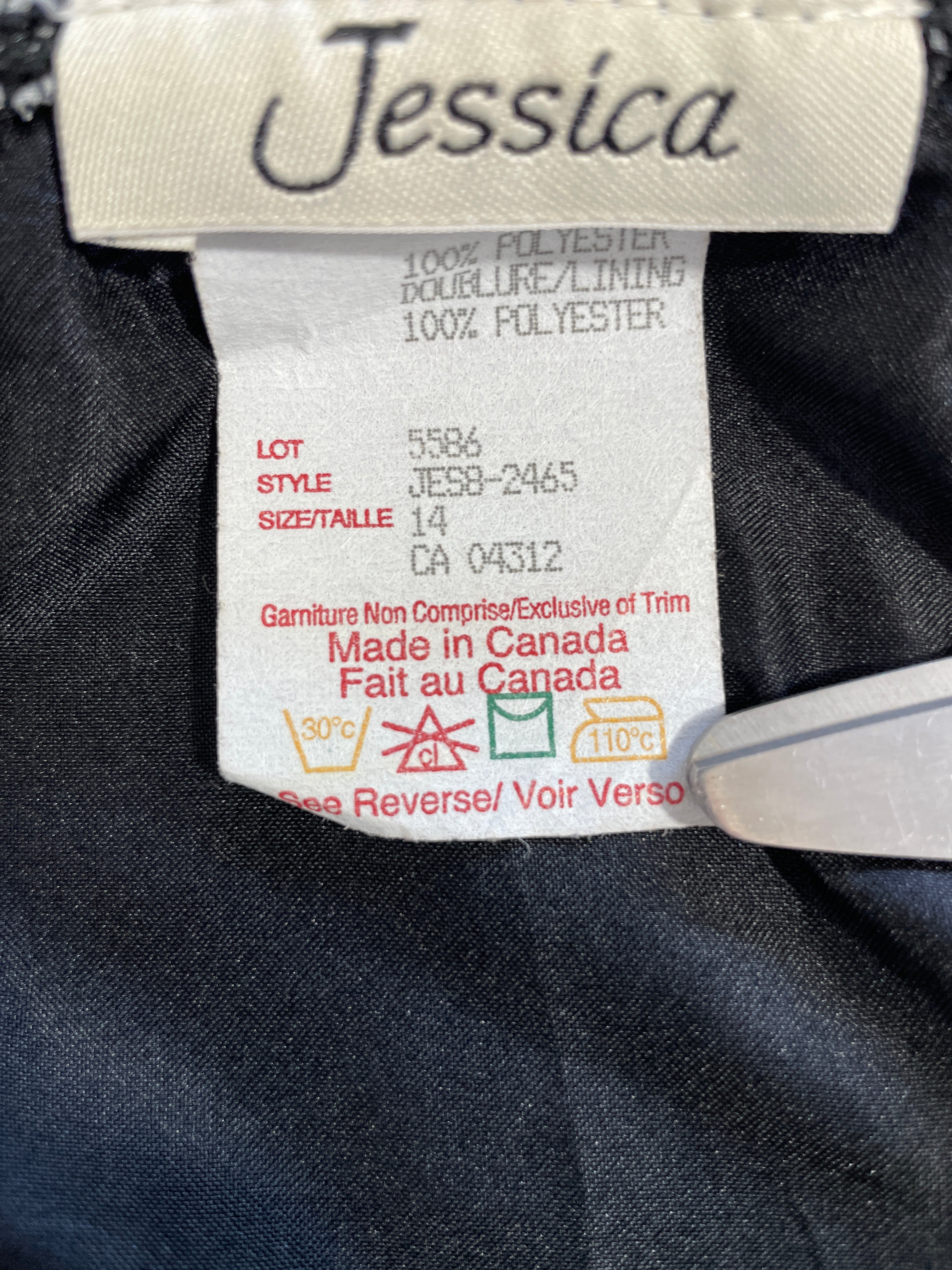 Close-up of a garment's interior label showing the brand 'Jessica' and product details including '100% Polyester' and 'Made in Canada'.