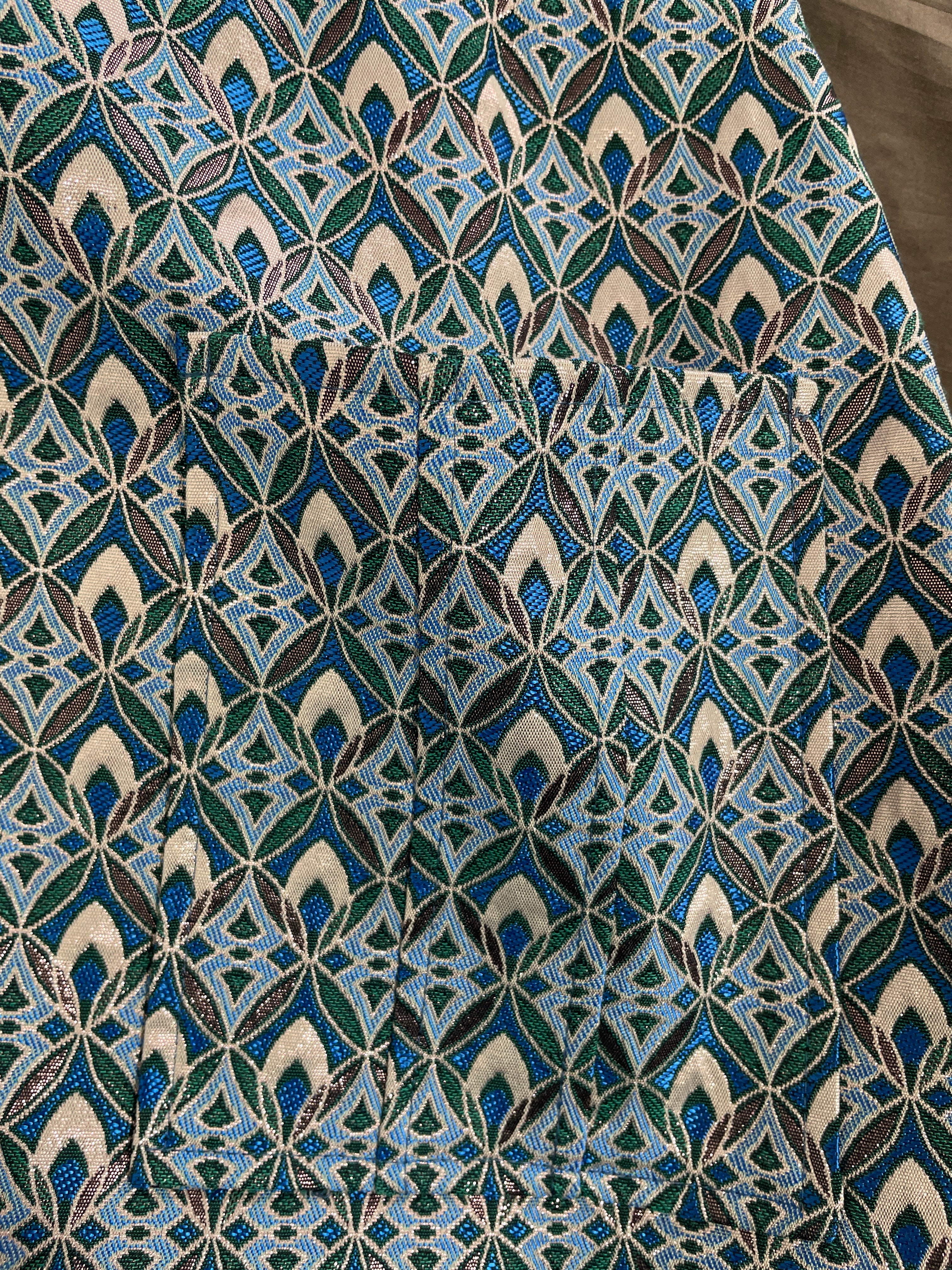 Close-up of Maje blue green and blush geometric woven jacquard skirt fabric