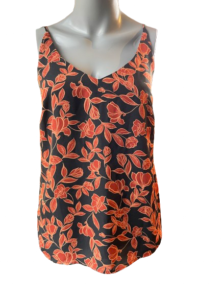 A black floral flowing tank top displayed on a mannequin with orange and rust-colored flowers on a black background.
