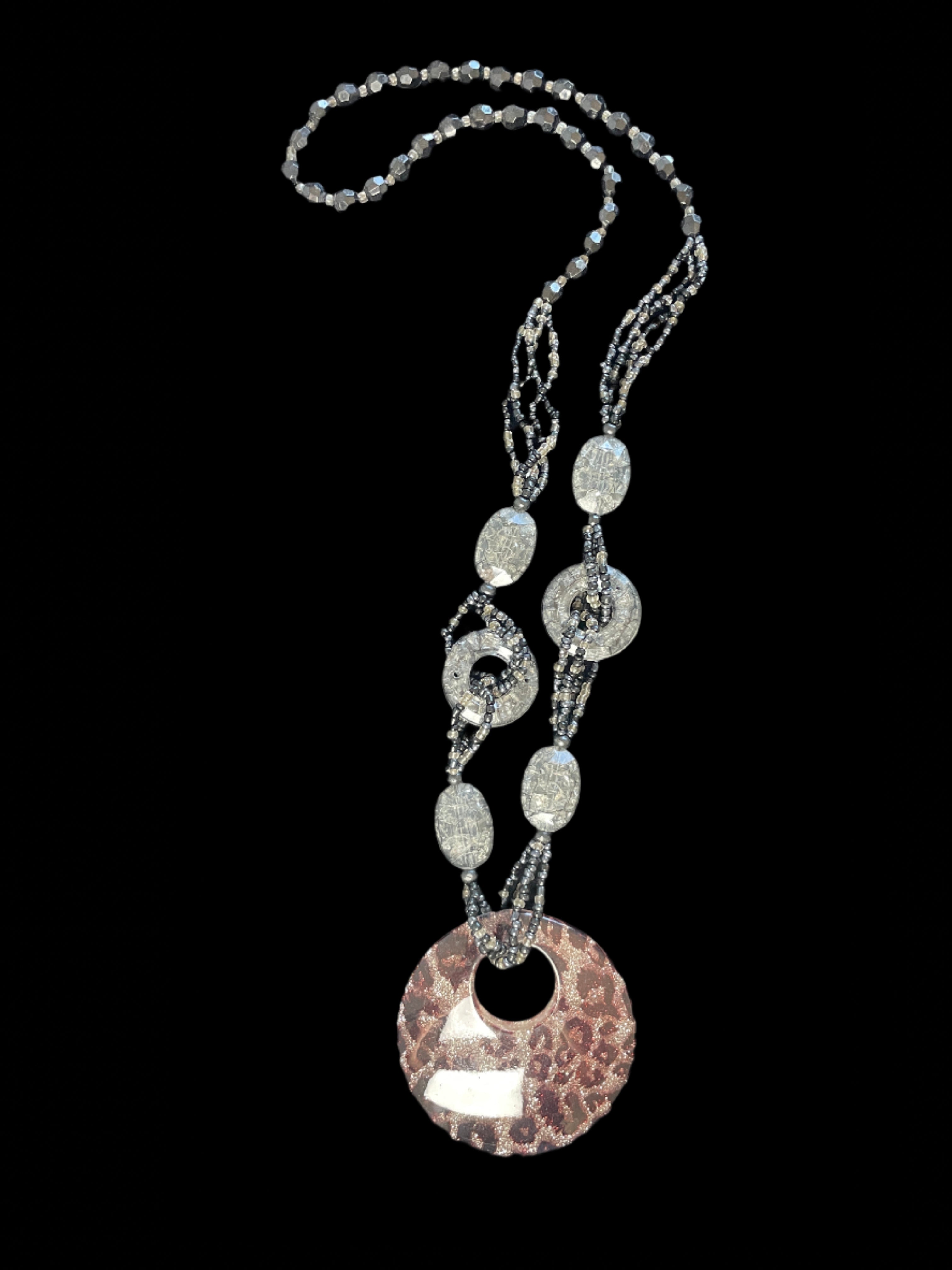 Necklace with decorative pendant on a black background