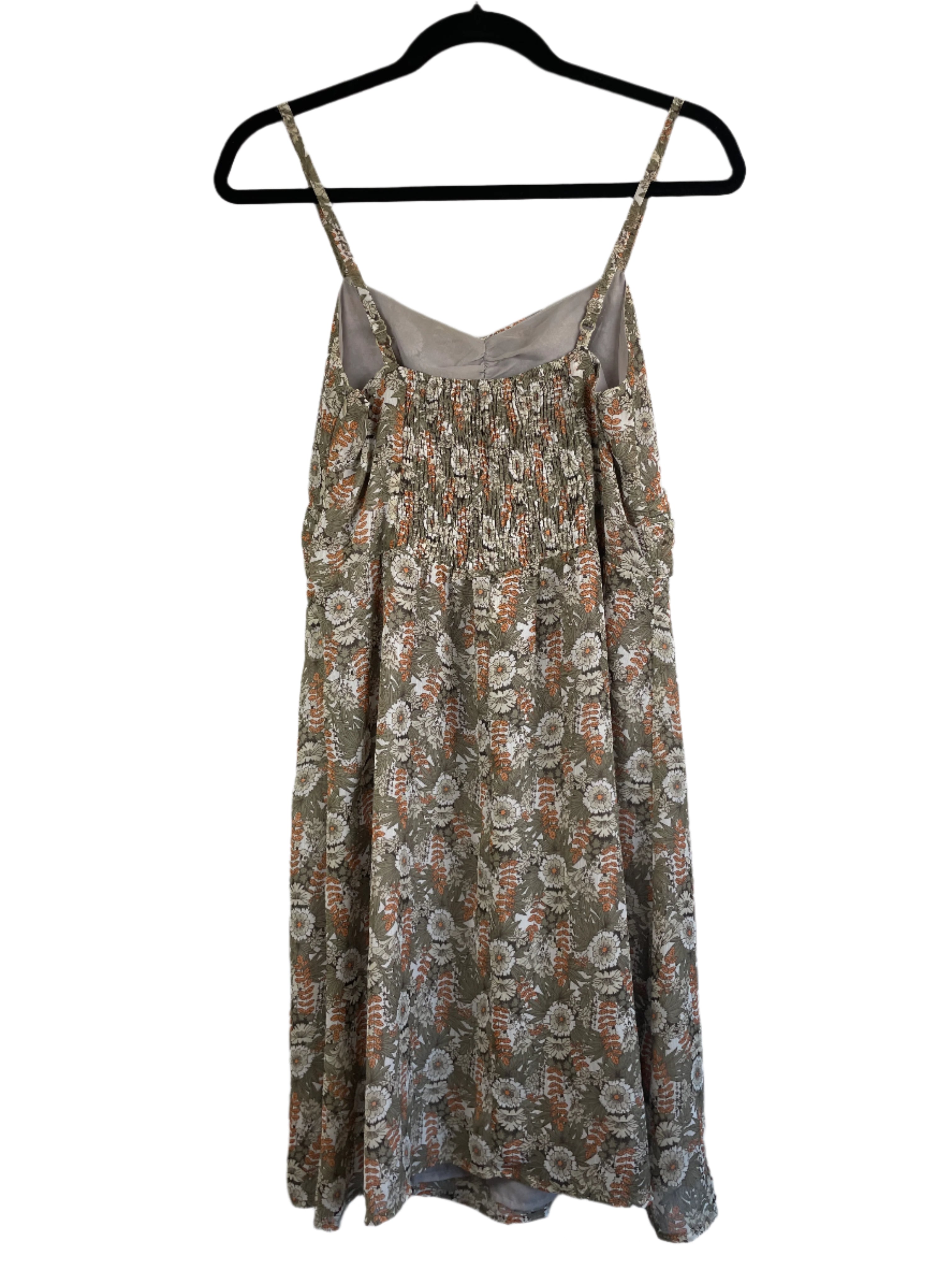 Back view of Romy floral dress showing smocked elastic panel and adjustable straps