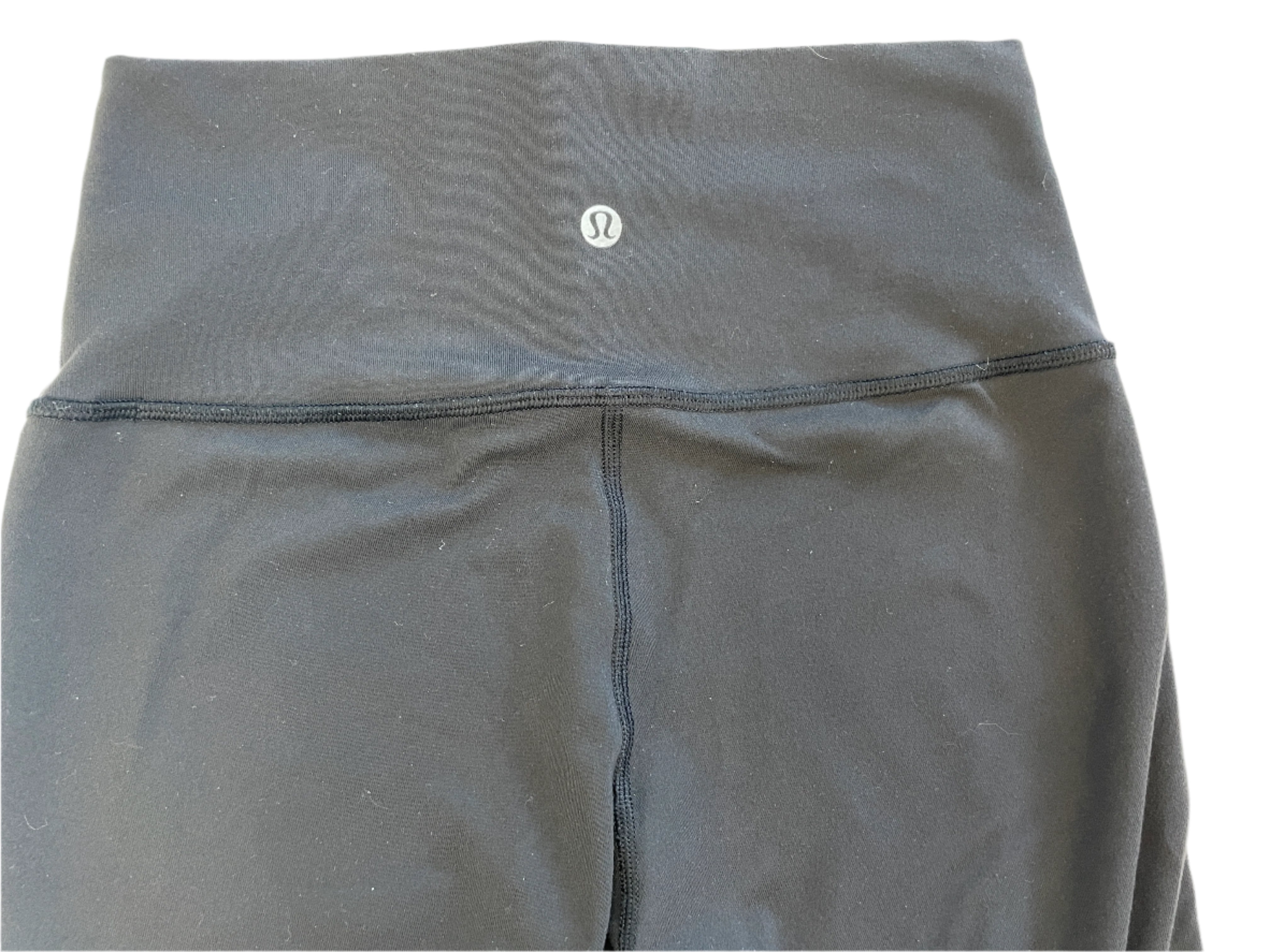 Black lululemon leggings with a brand logo on a light gray background
