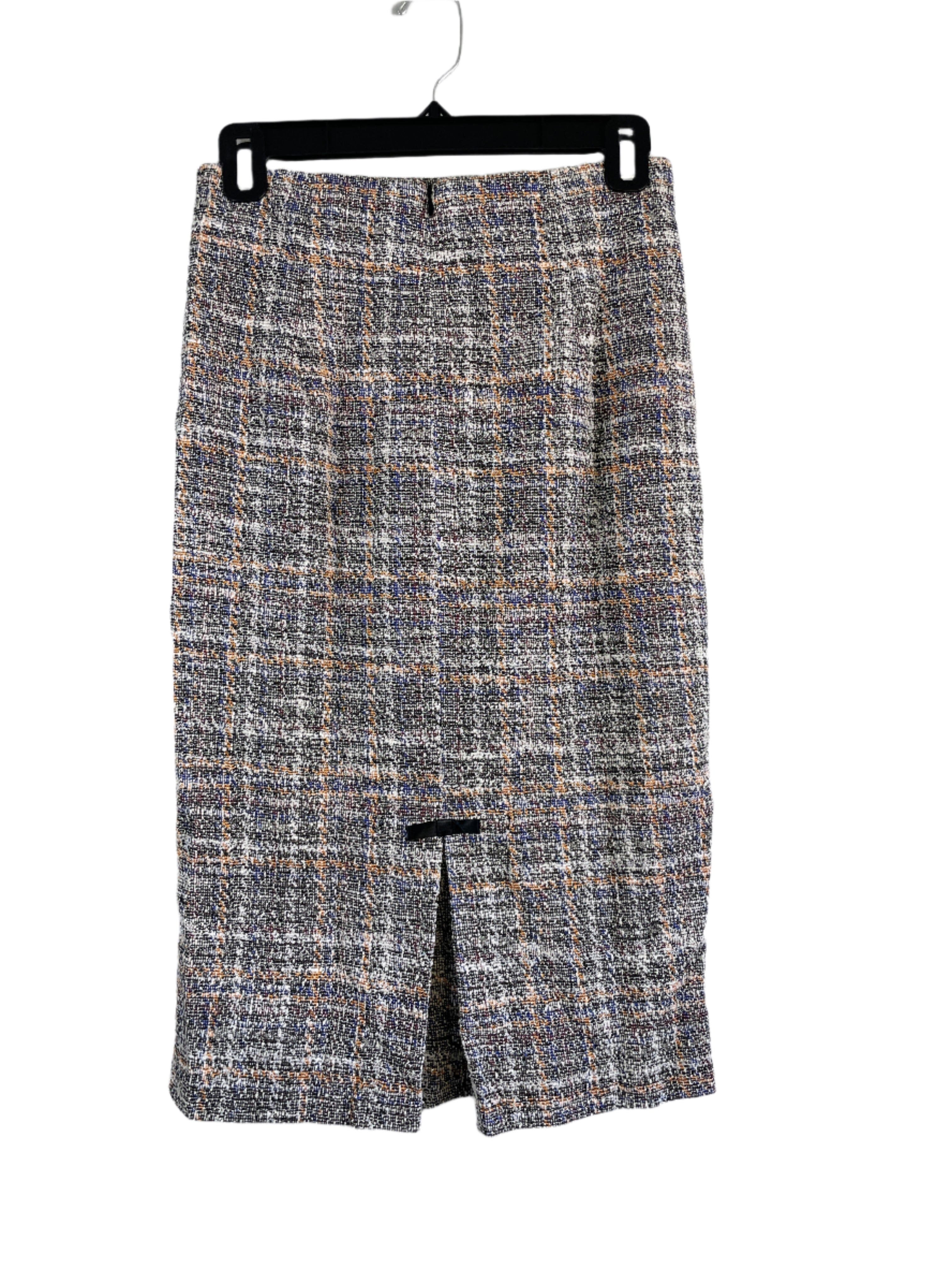 Back view of beige and multicolour Belle Pogue pencil skirt with satin bow detail, size small, displayed flat against a neutral wall.