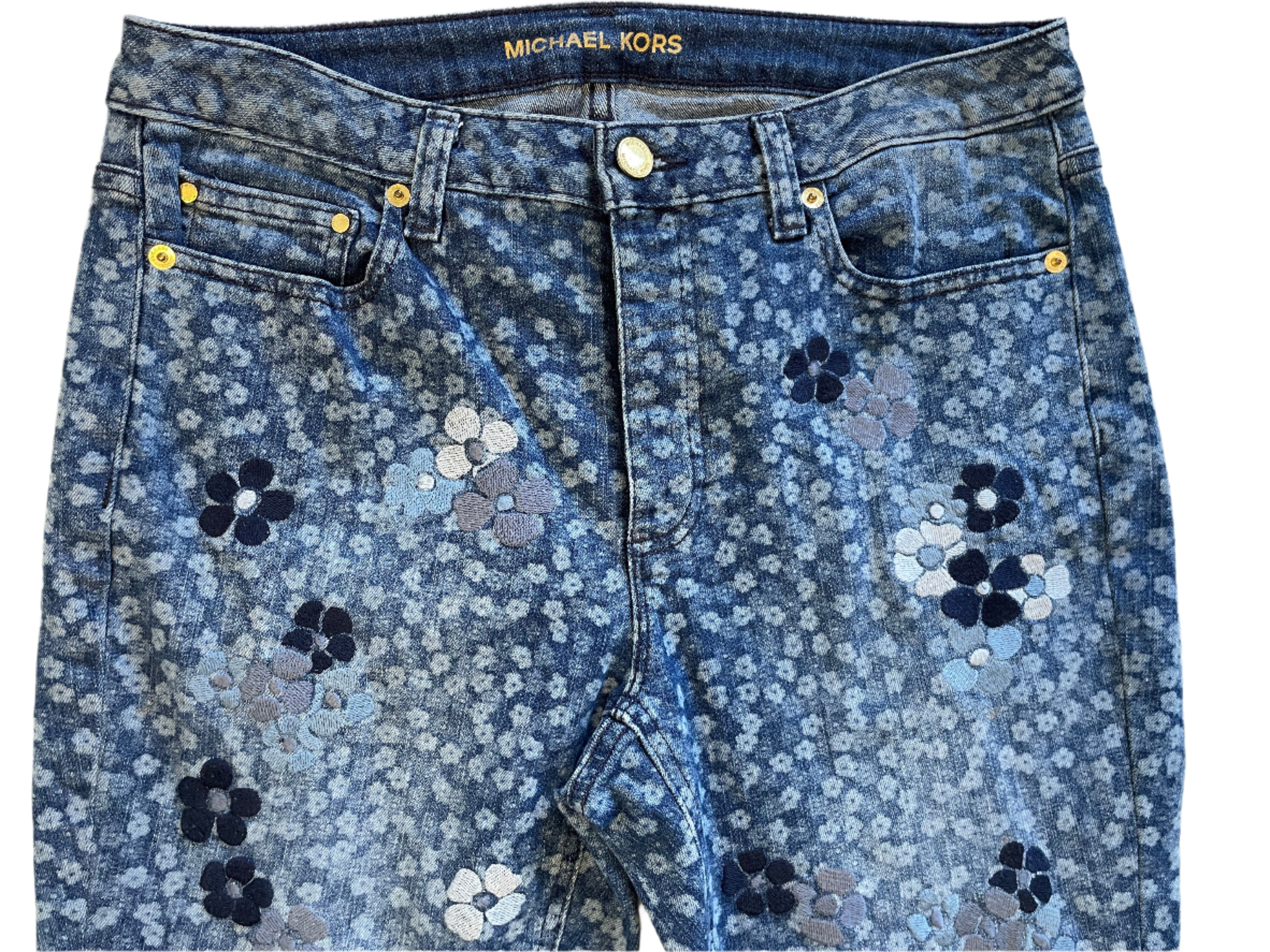 Blue floral-patterned jeans by Michael Kors on a white background