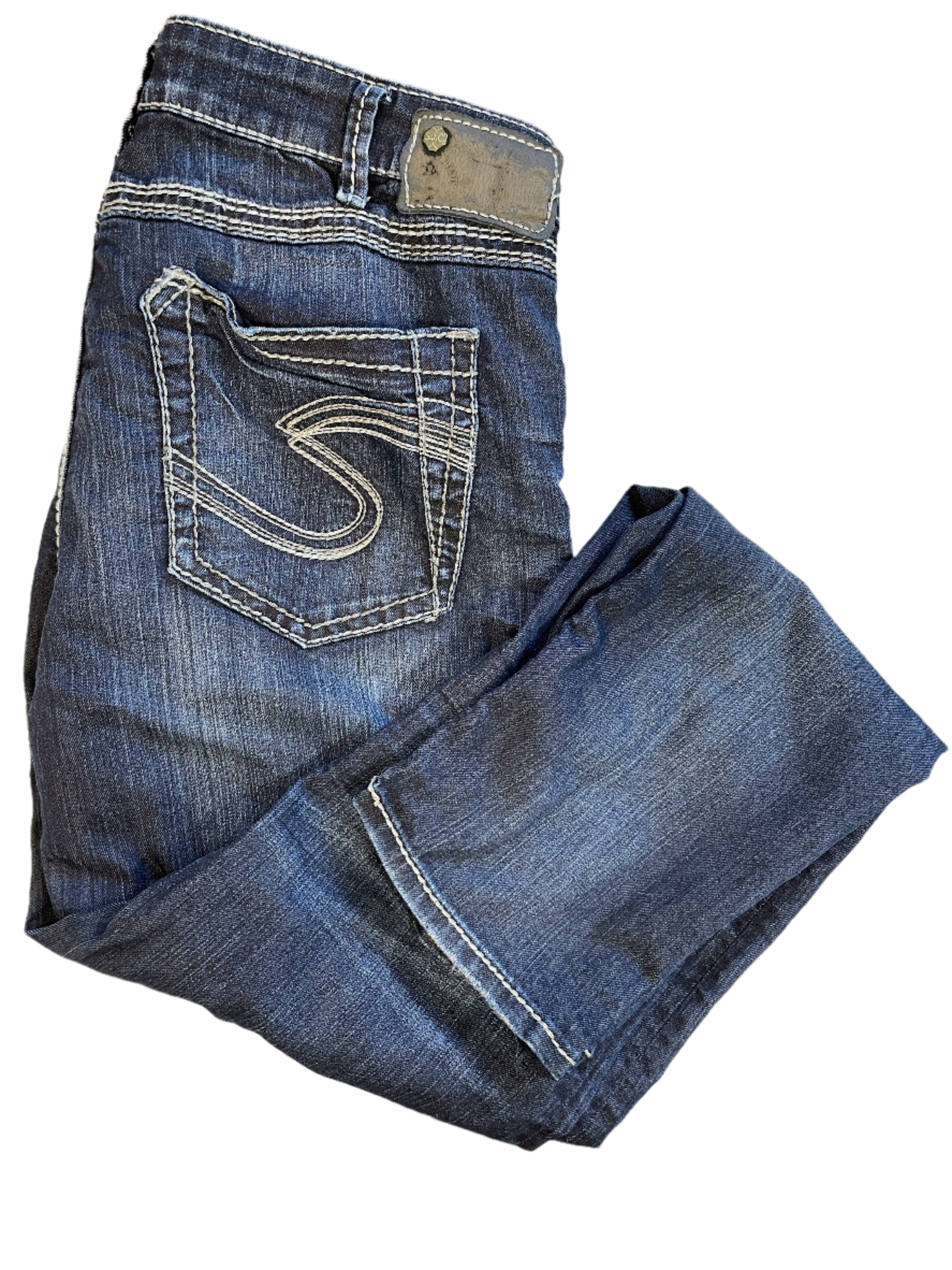 Folded Silver Tuesday jeans showing back pocket embroidery and dark wash