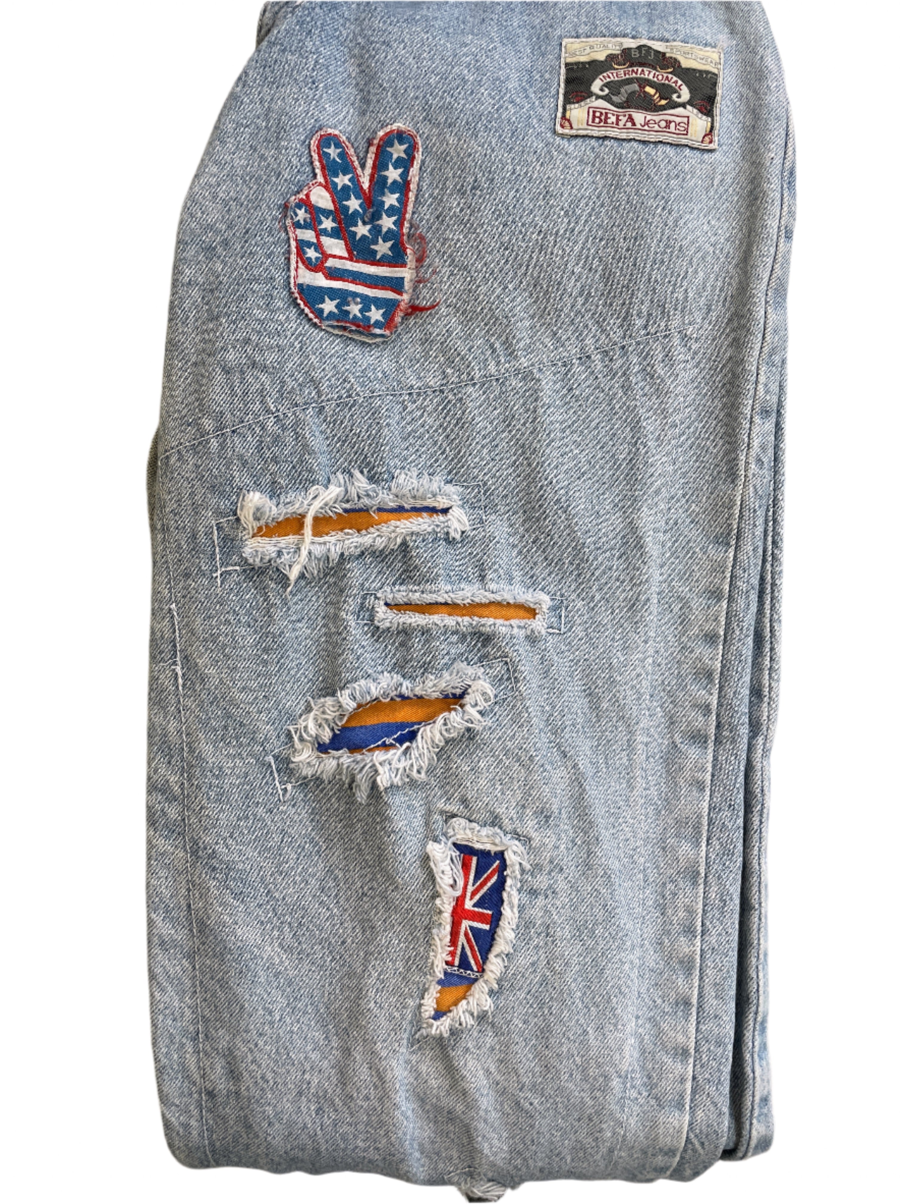 Side leg detail showing stars & stripes peace sign and fabric in distressing