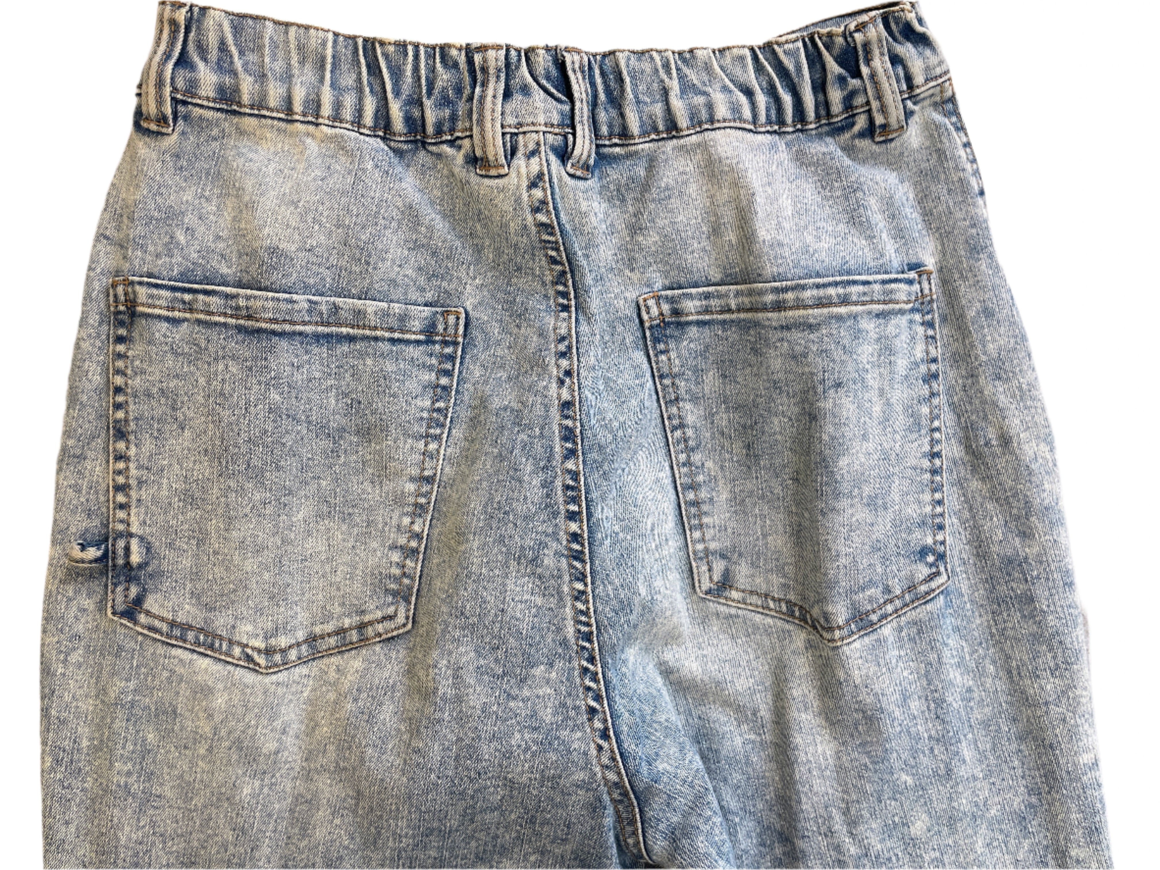 Pair of blue jeans laid flat on a surface