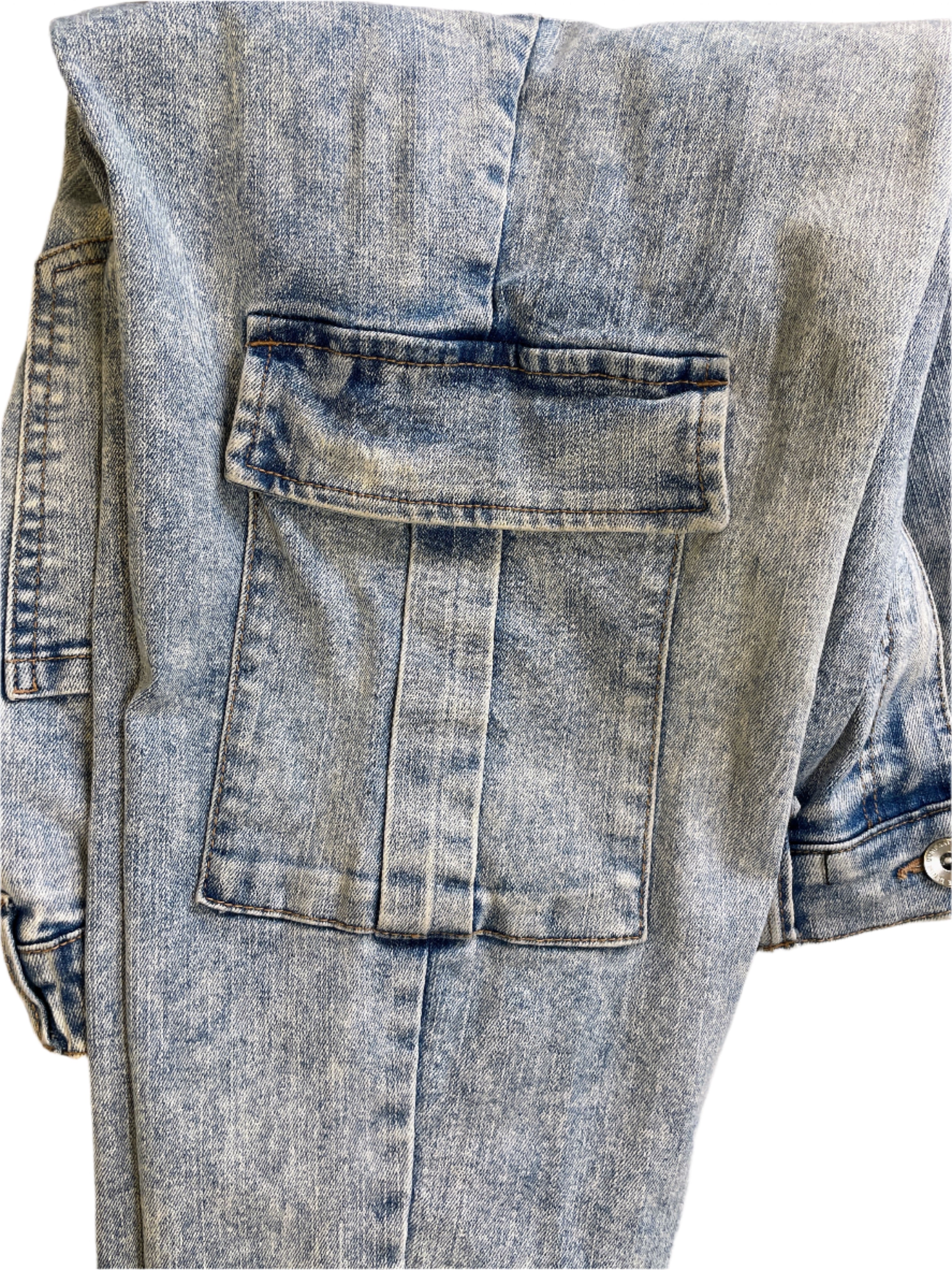 Folded denim jacket on a neutral background