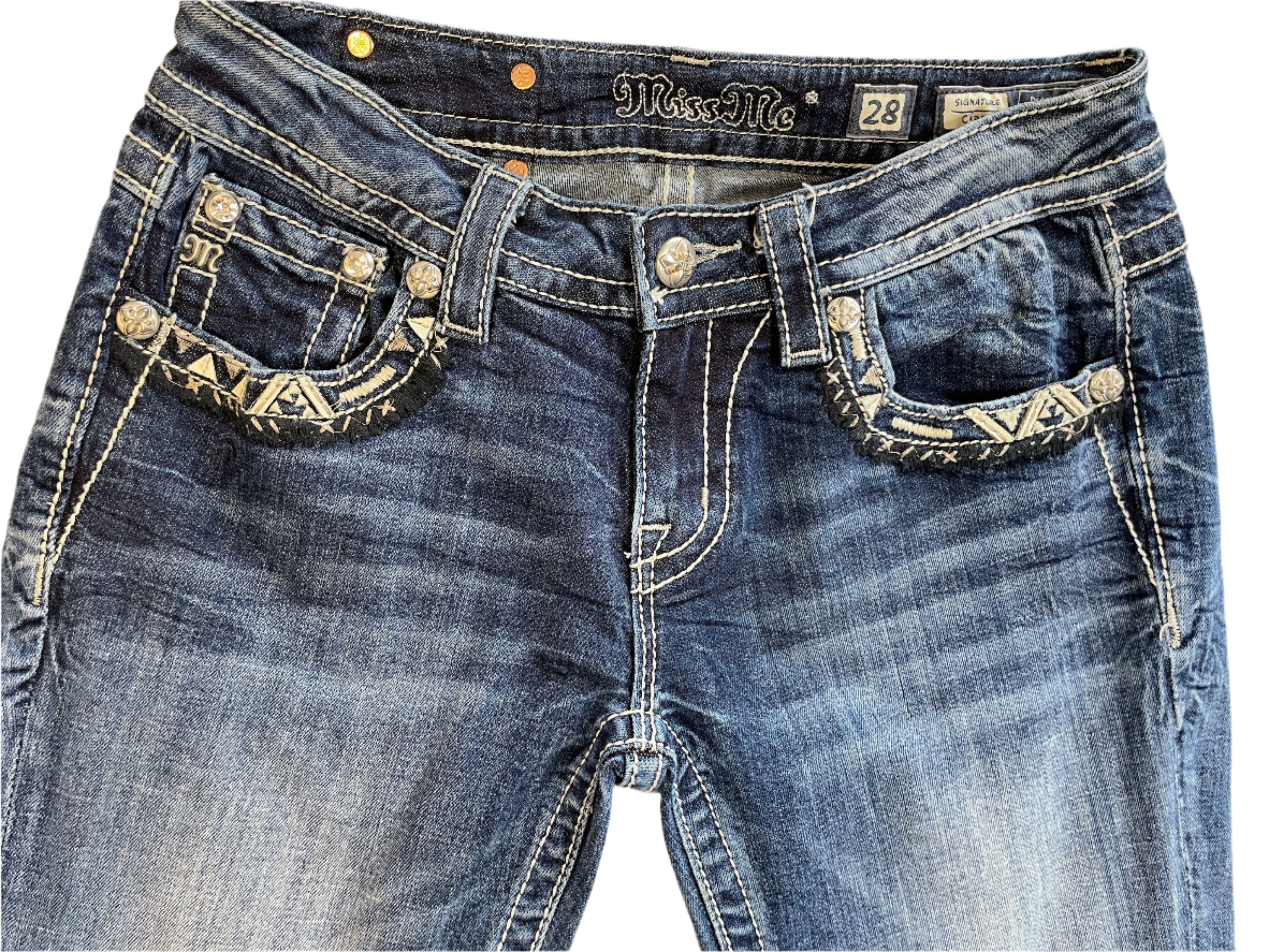 Blue jeans with decorative stitching on a plain background