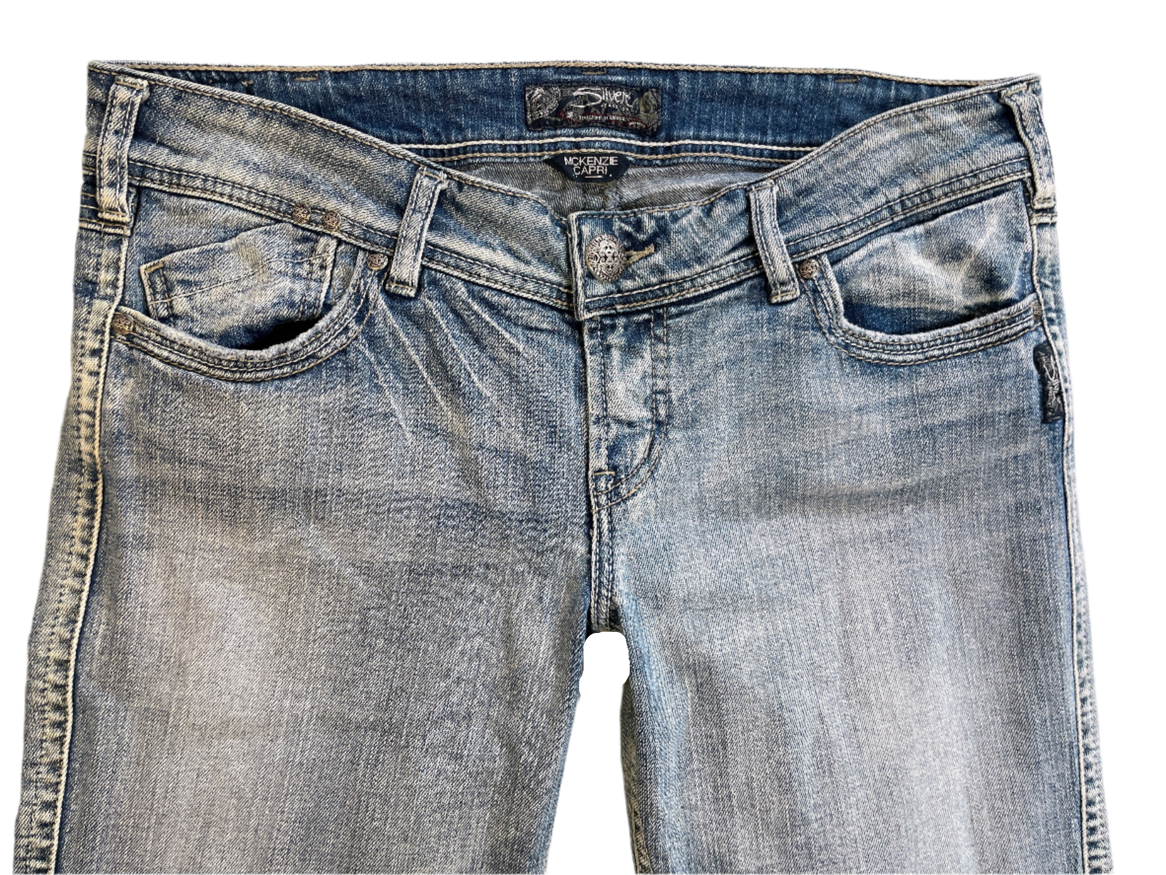 Pair of blue jeans with a brand label on a white background