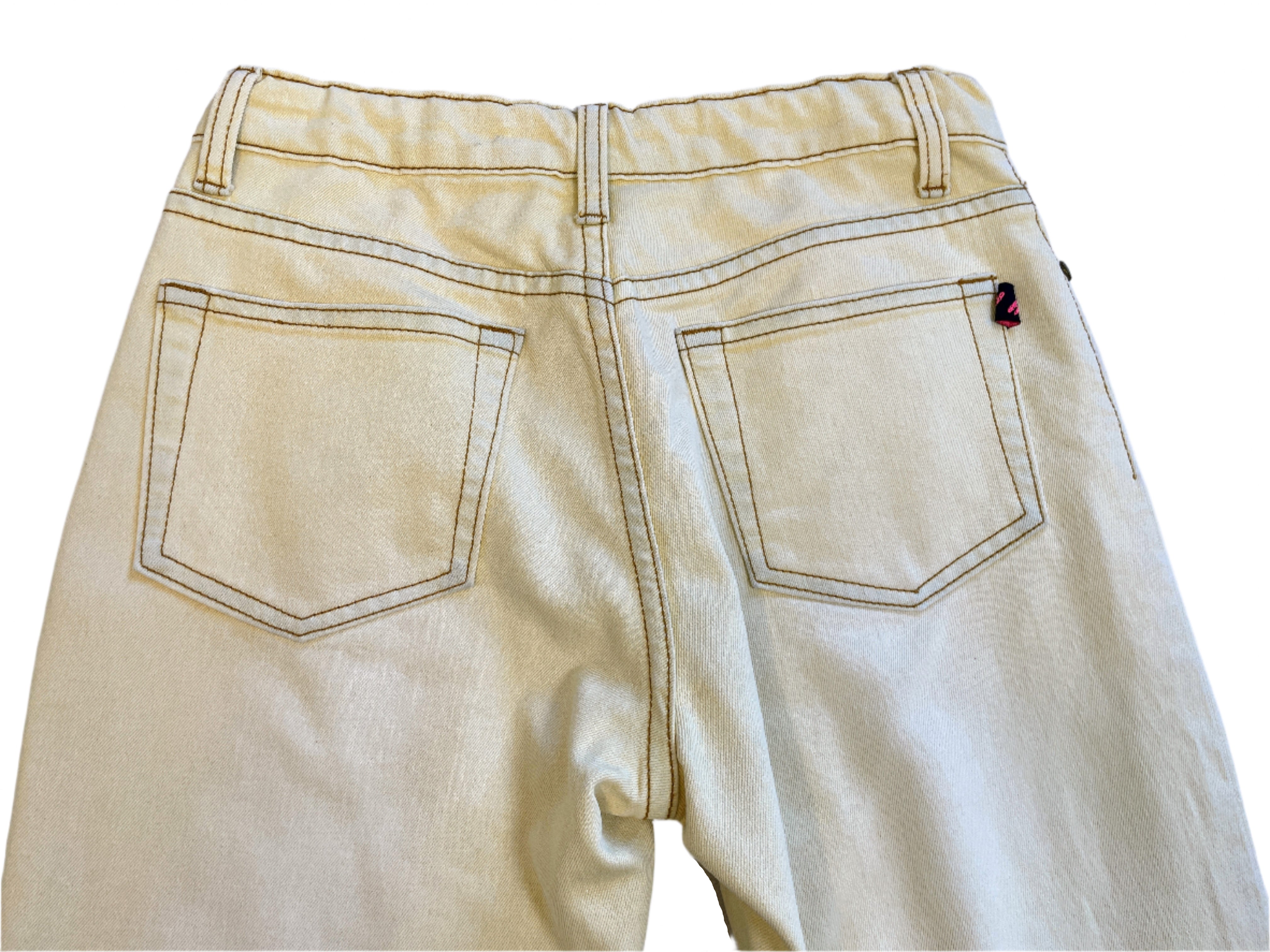 Back view of light-colored pants on a gray surface