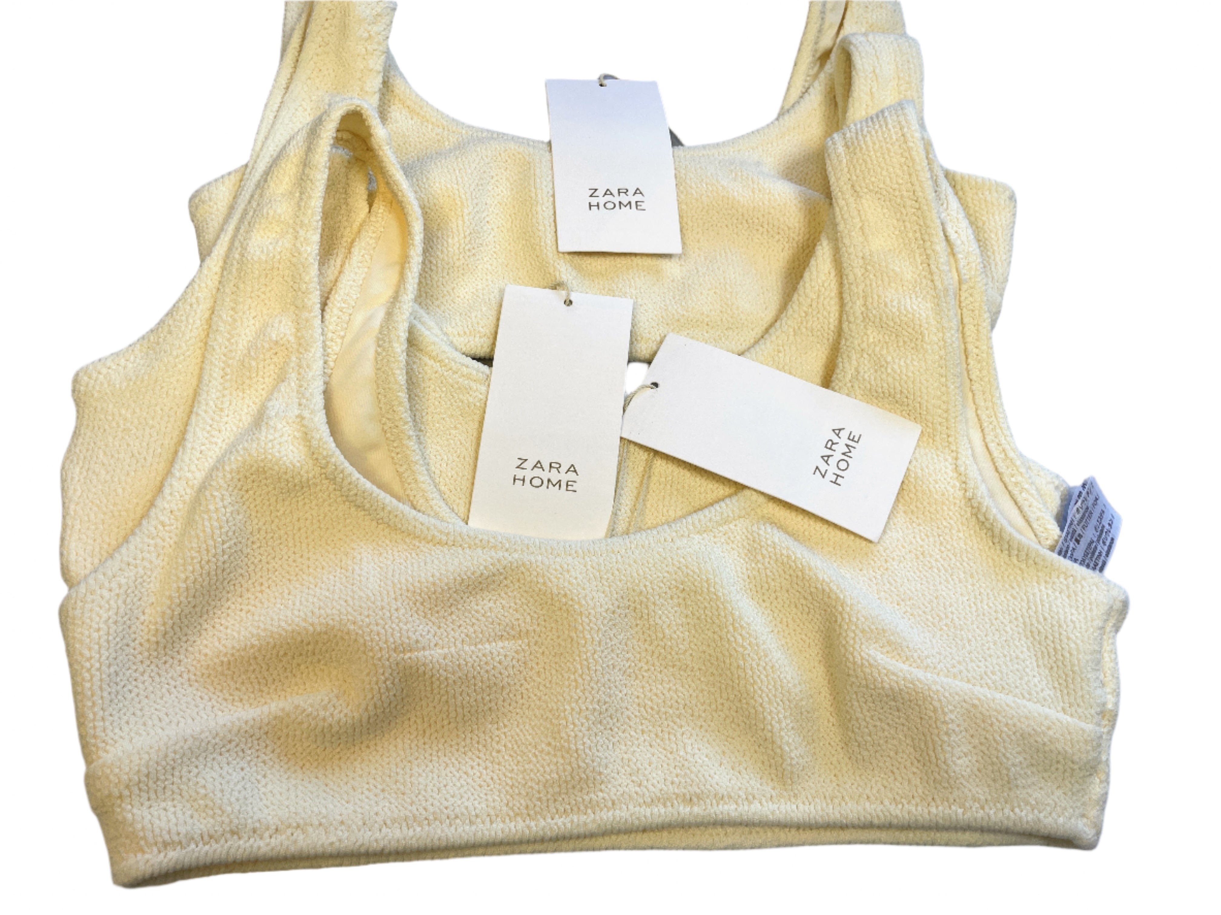 Yellow textured top with Zara Home tags on a gray surface