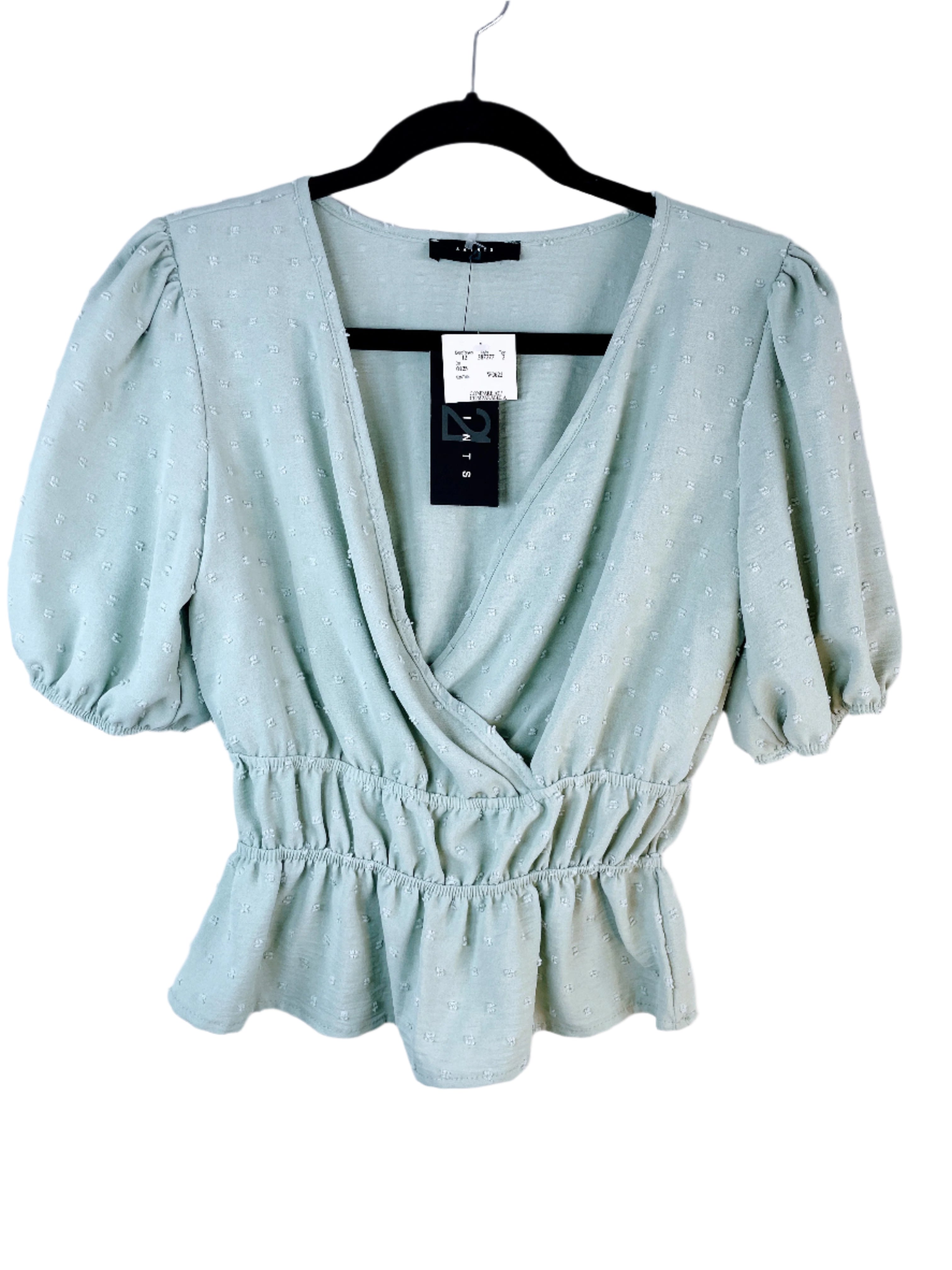 Front of 21 Saints sage green peplum wrap blouse with puff sleeves, size medium, new with tags.