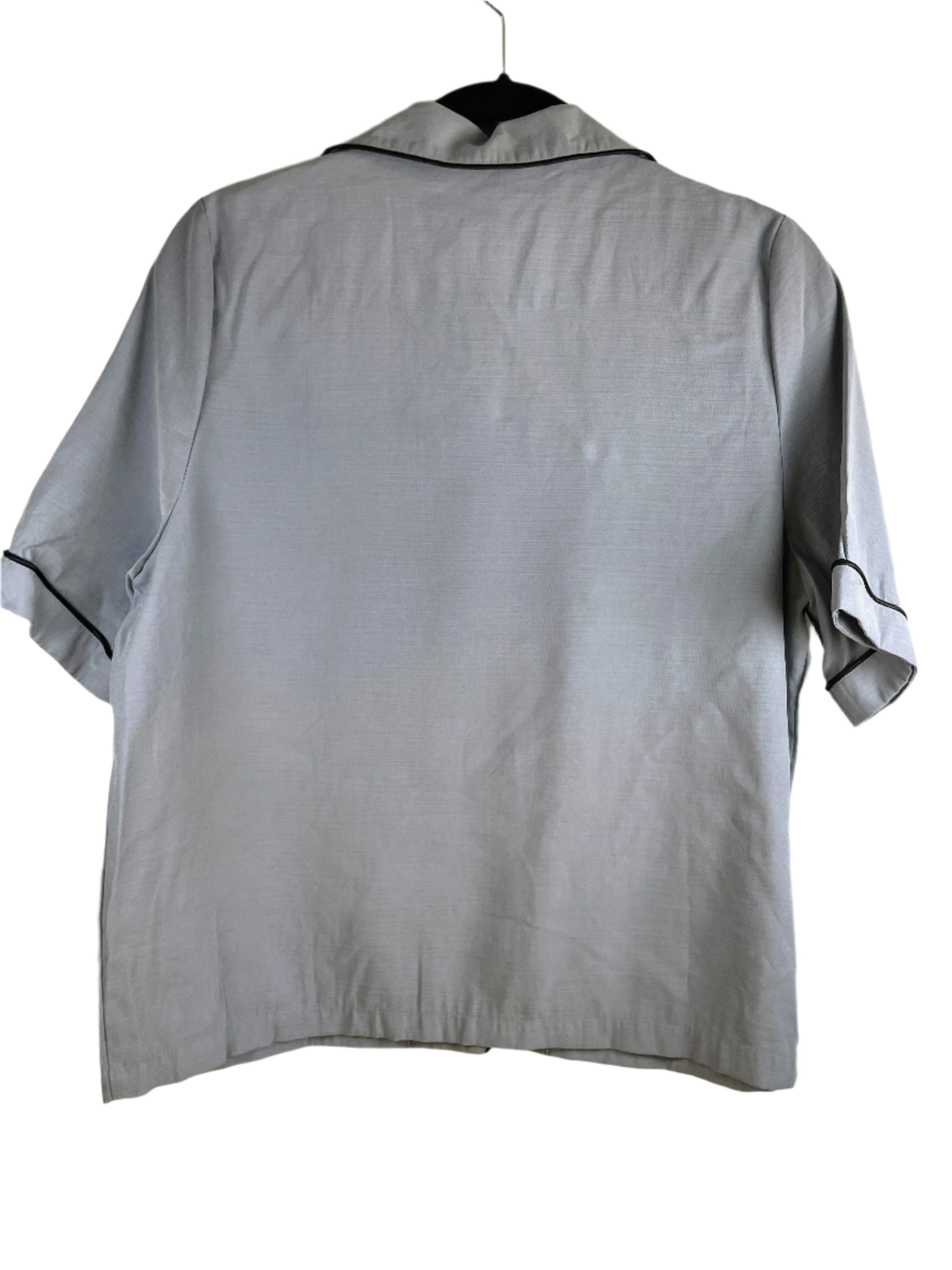 Light blue Zara Home pyjama top with navy piping, short sleeves, and button front