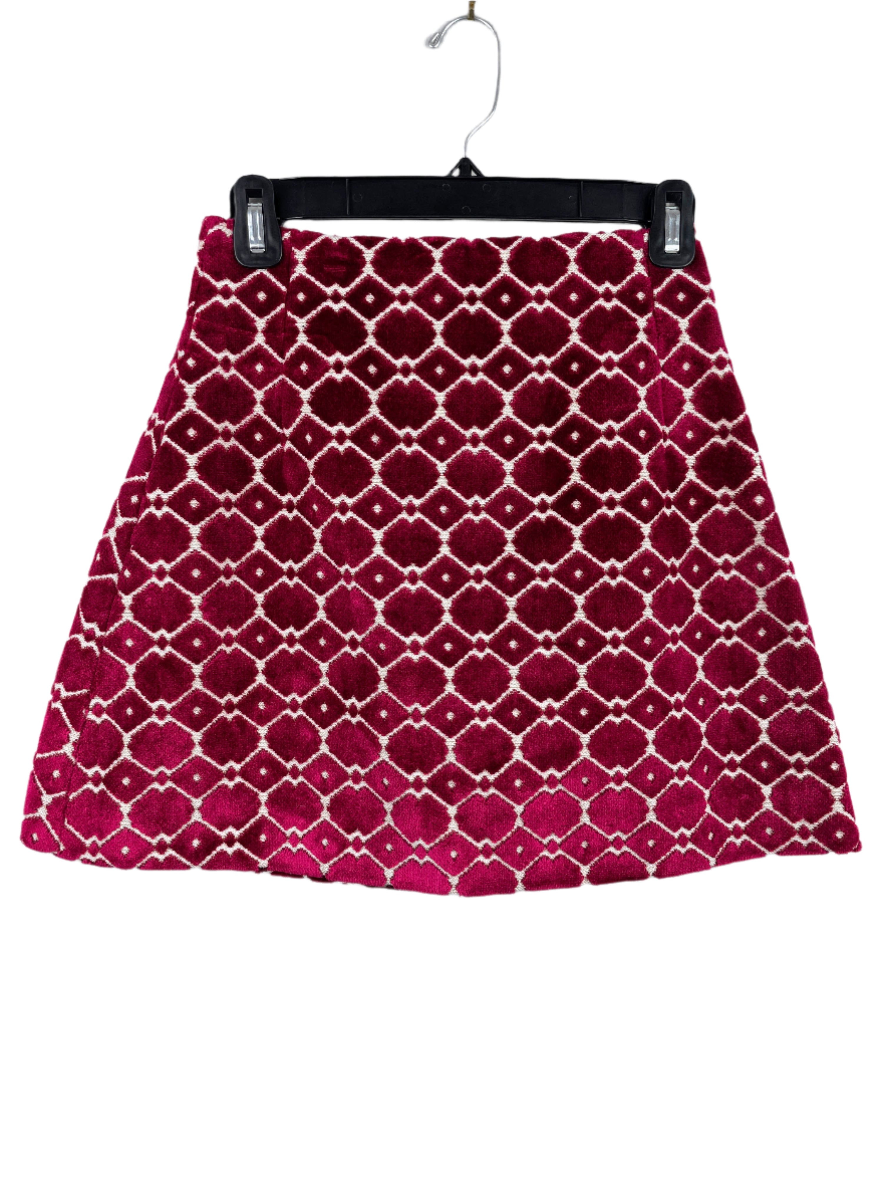 Front views of a burgundy and cream mini skirt with geometric velvet design and back zipper, size small.