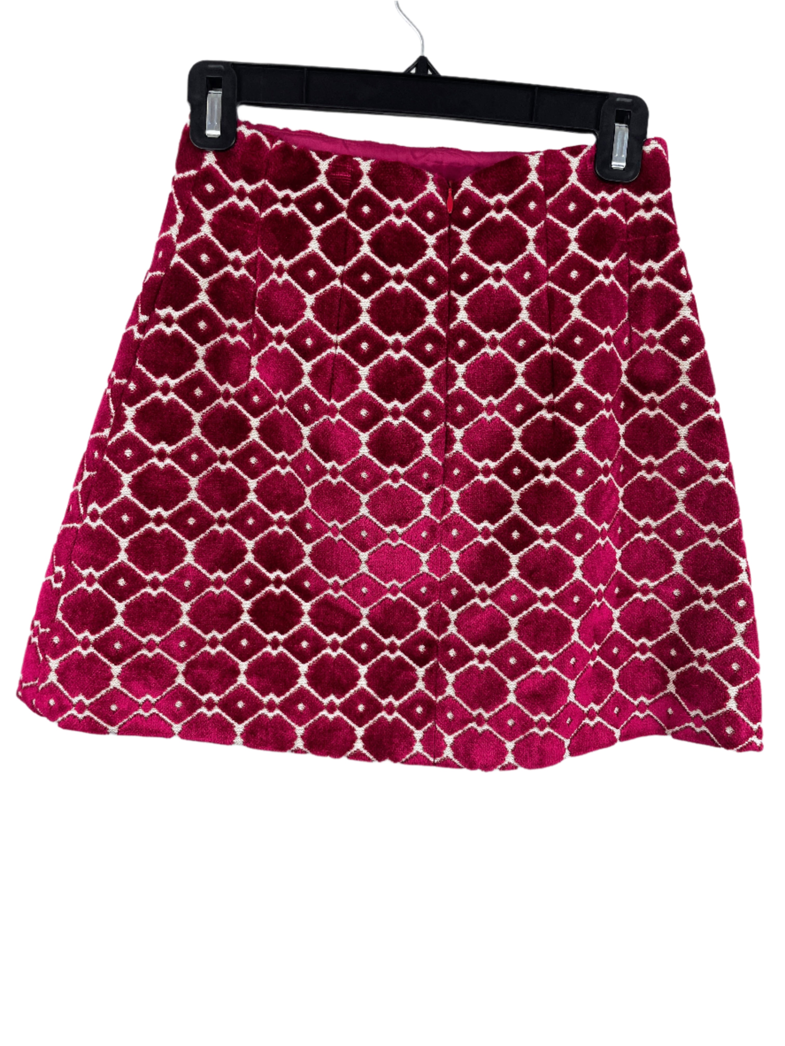 back views of a burgundy and cream mini skirt with geometric velvet design and back zipper, size small.
