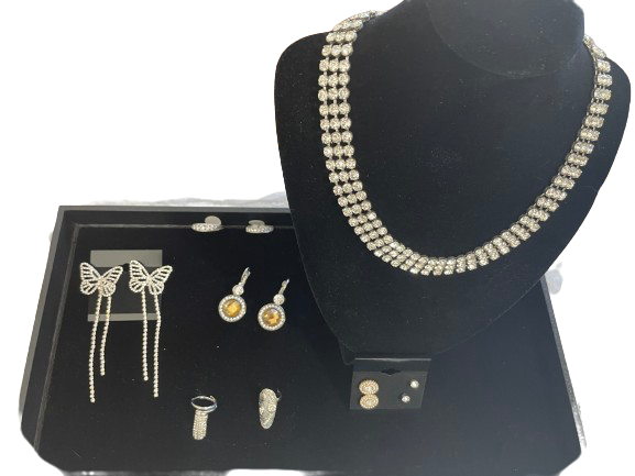 Jewelry set including a necklace and earrings on a black stand with a white background