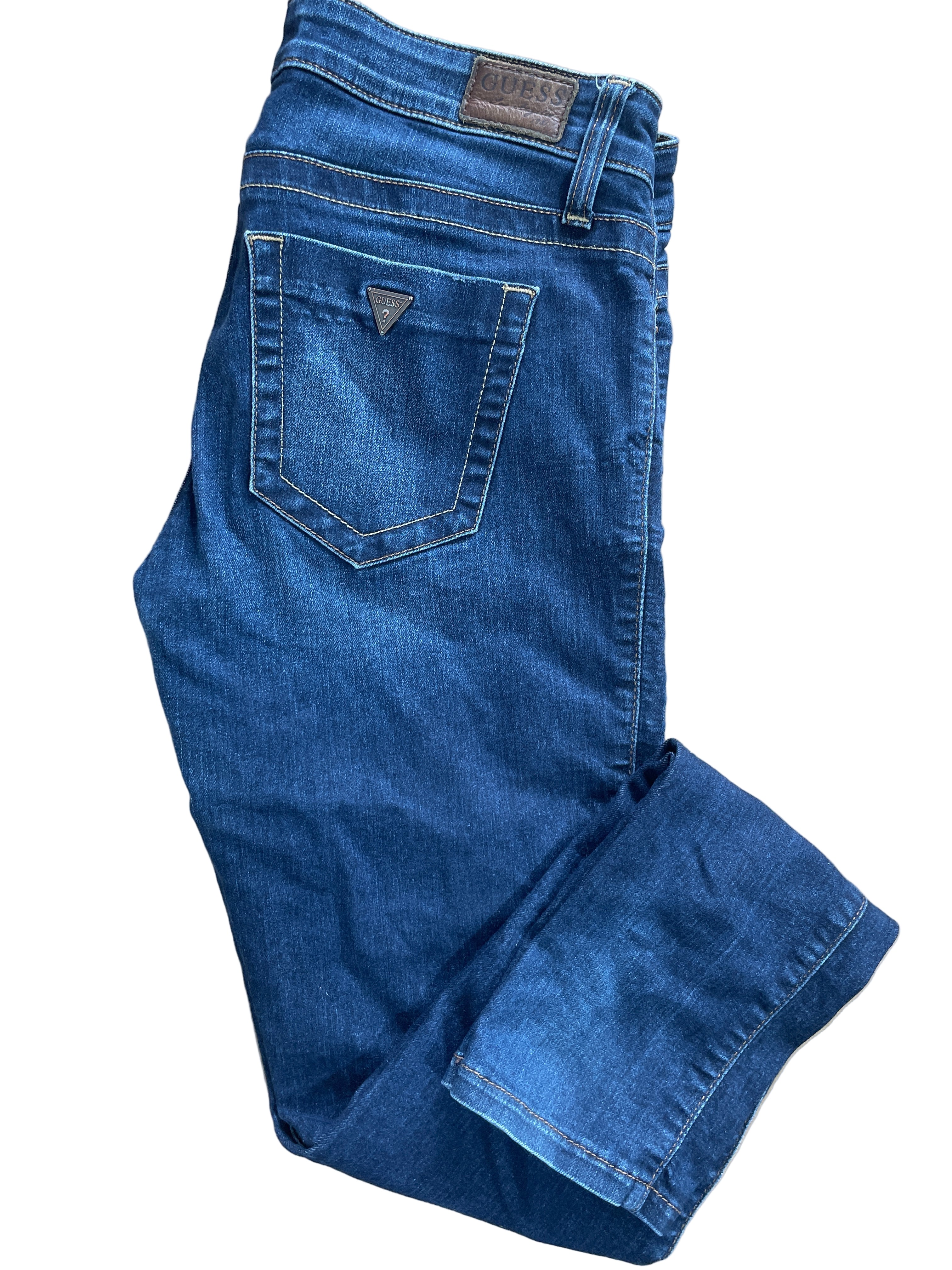 Guess Power Ultra Skinny jeans in dark wash, size 27, five-pocket design with zipper fly and button closure, back pockets feature Guess logo