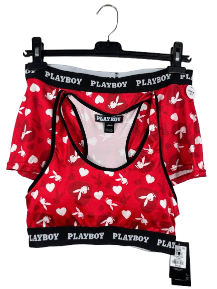 Red Playboy lingerie set with white hearts and black lettering on a hanger against a white background.