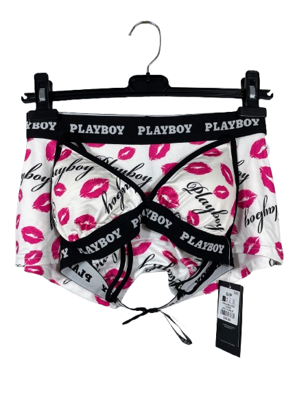 Playboy branded underwear set with pink lip prints on a hanger against a white background