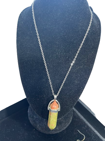 Necklace with a pendant on a blue stand