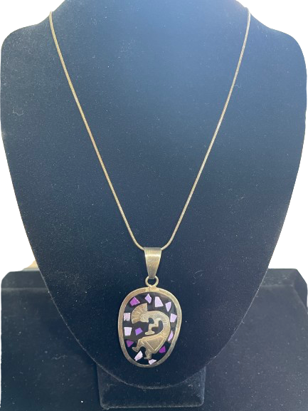 Sterling silver necklace with purple mosaic inlay pendant displayed on stand