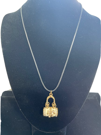 Gold necklace with a lock-shaped pendant on a black stand
