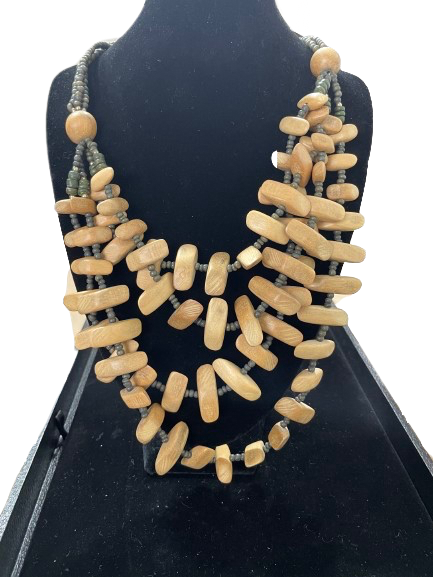 Multi-strand chunky wooden bead necklace with light wood and grey spacer beads.