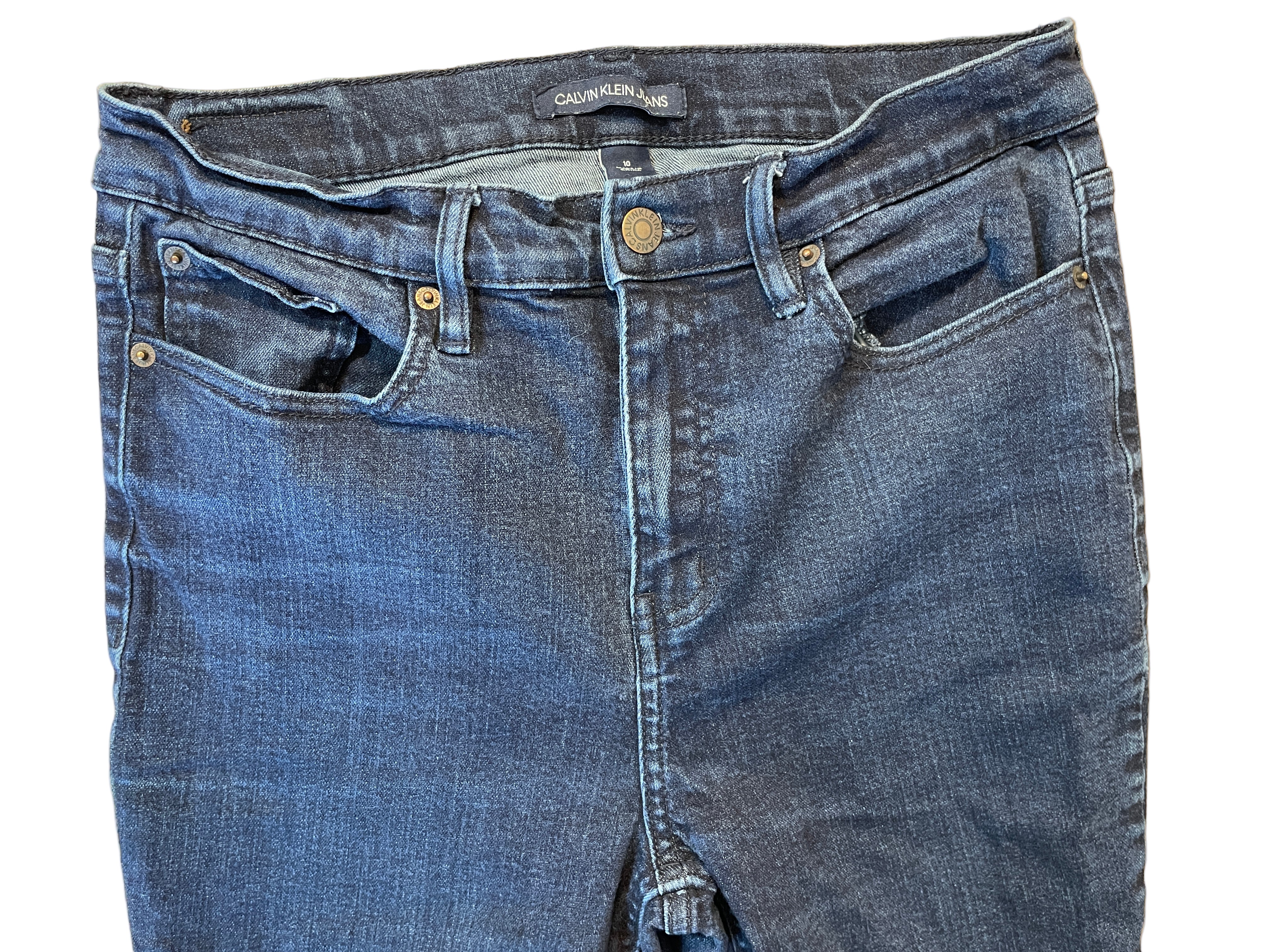 Front view of Calvin Klein dark wash skinny jeans with zipper fly and button closure
