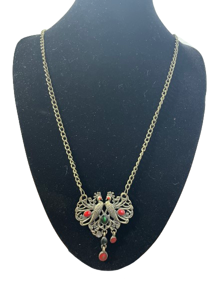 Antique gold peacock pendant necklace with red and green stones