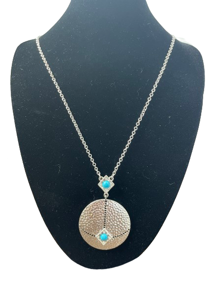 Silver pendant necklace with turquoise stones and textured circle design