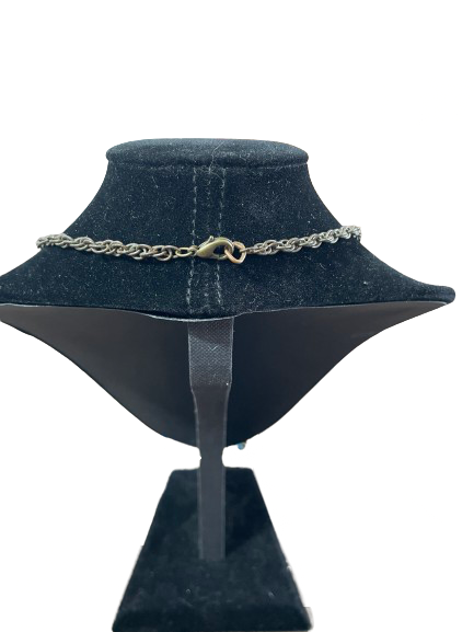 Chain necklace on a black mannequin bust with a white background