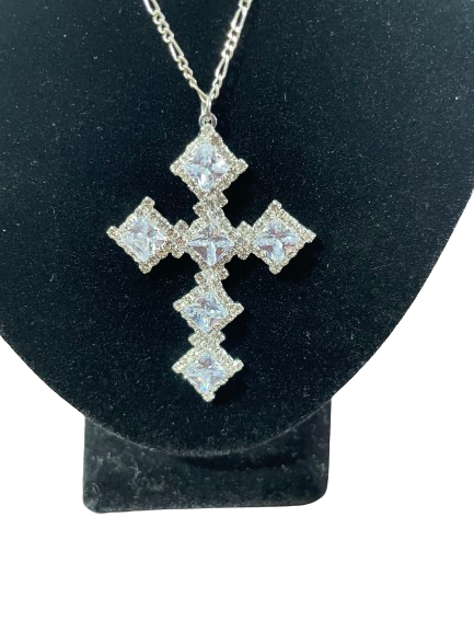 Rhinestone cross pendant close-up showing faceted stones and setting detail