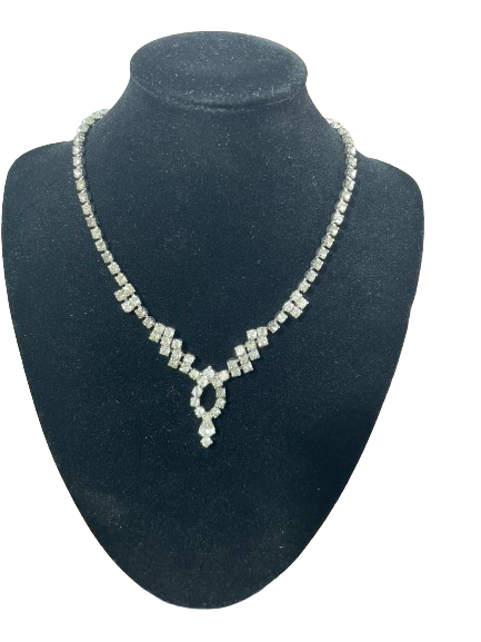 Vintage rhinestone necklace front view showing silver-tone setting and central drop detail
