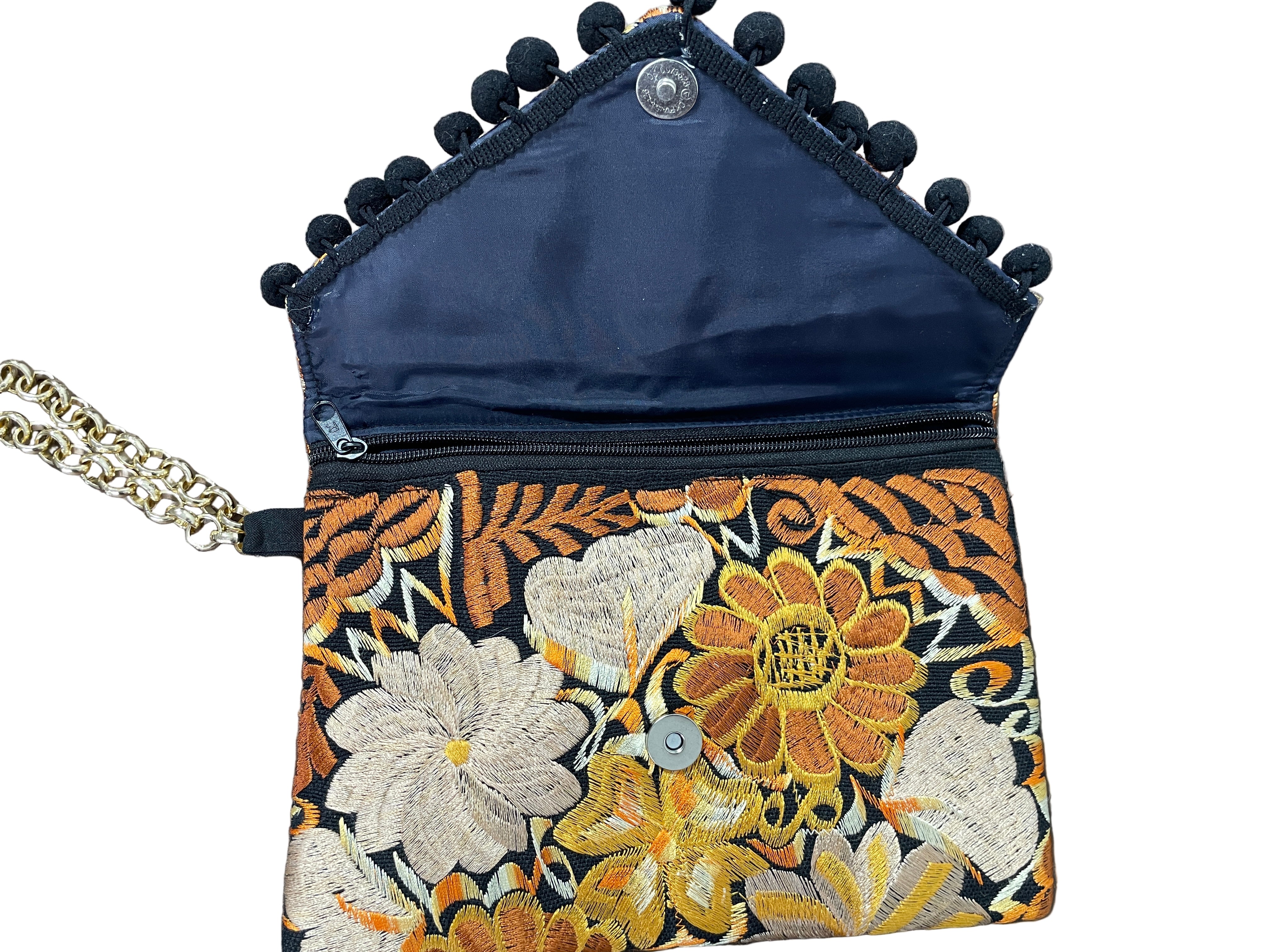 Open view of wristlet showing magnetic flap + zipper compartment