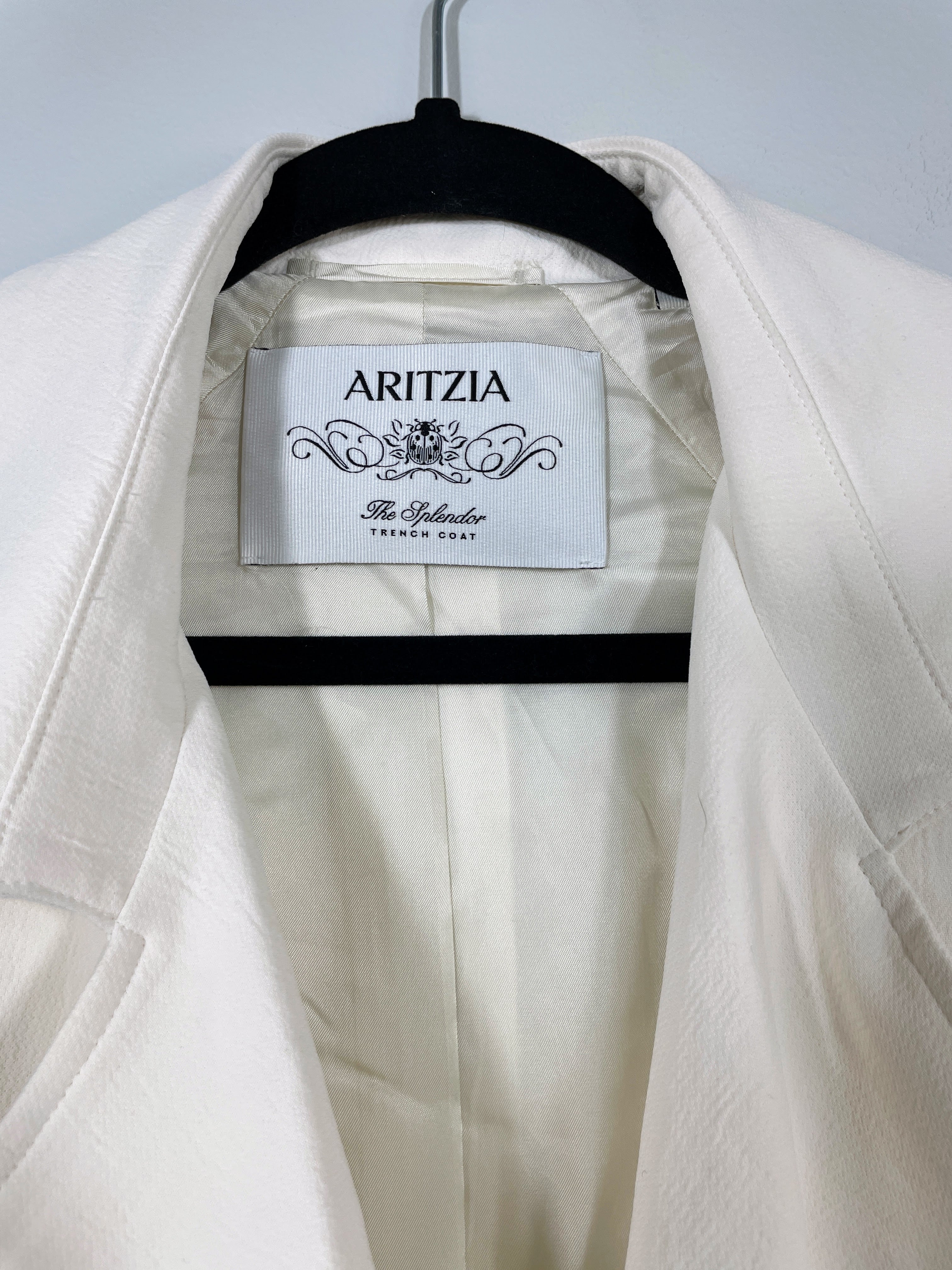 Aritzia Splendor trench coat light birch label close-up