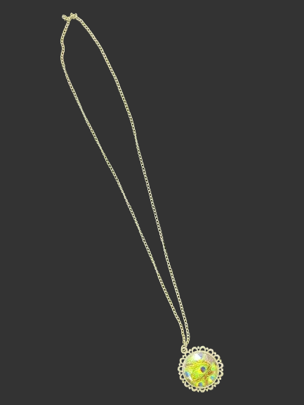 Gold tone peacock feather glass pendant necklace laid flat showing full chain length