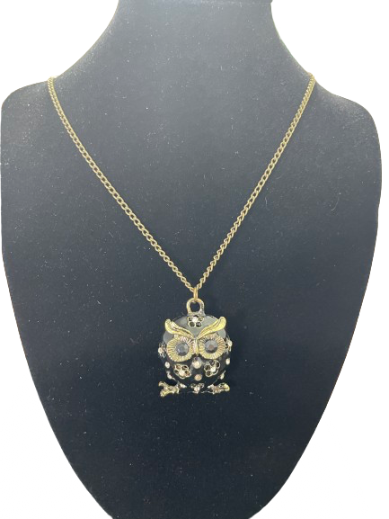 Gold tone costume jewellery owl pendant necklace displayed on black bust
