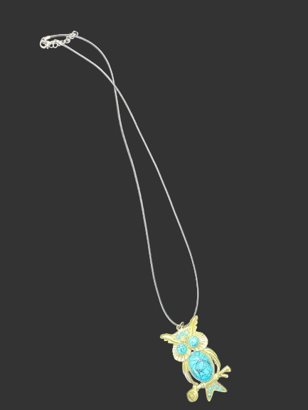 Owl pendant necklace laid flat with cord-style chain