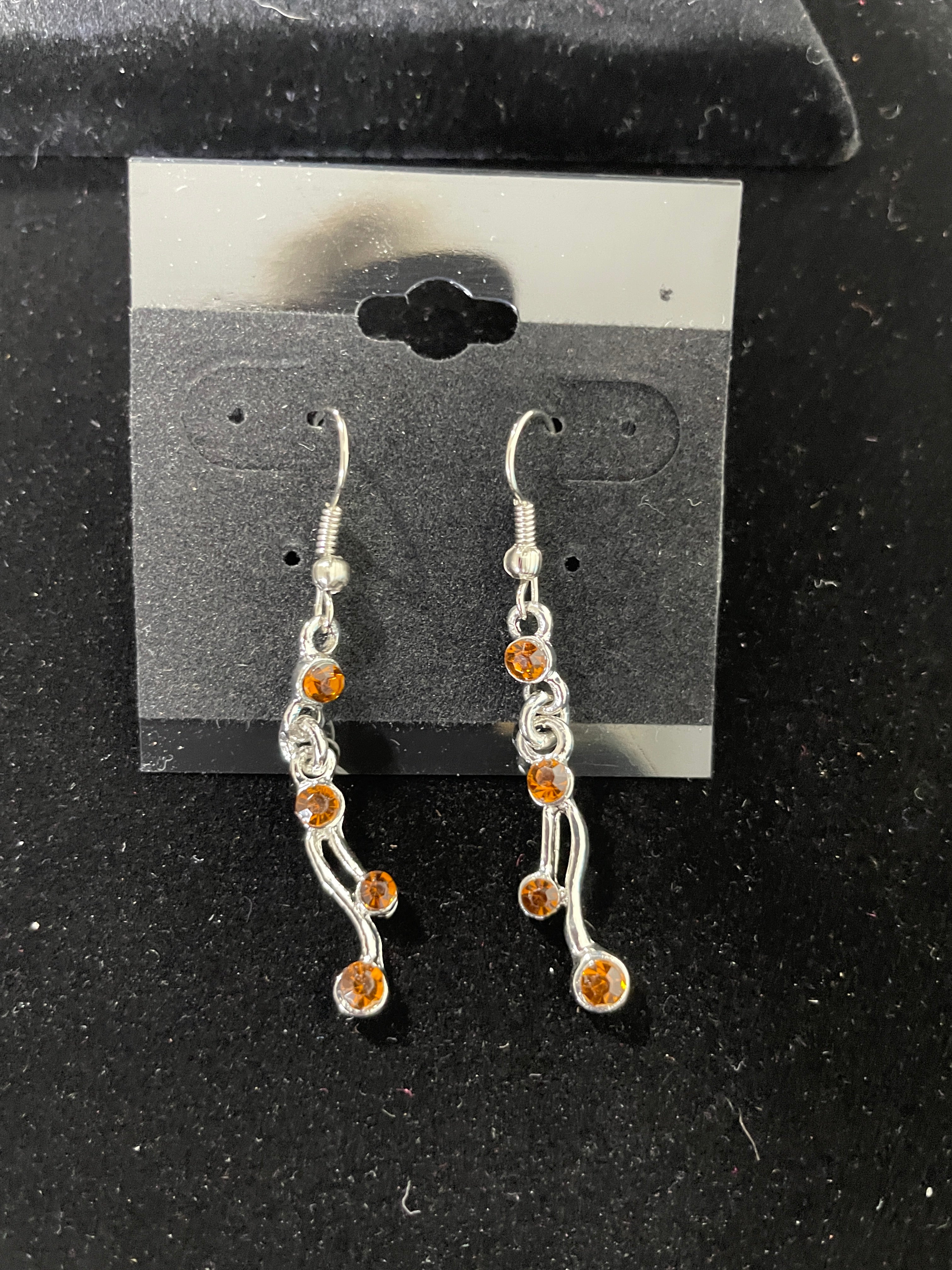 Silver tone amber rhinestone drop earrings close-up