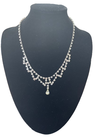 Front view of vintage rhinestone necklace with centre drop pendant on black bust