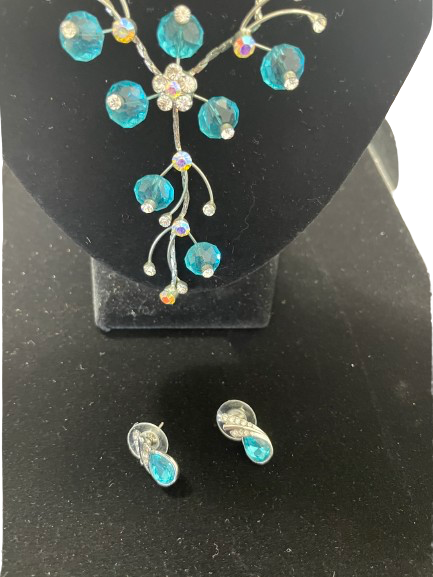 Close up of EBEN necklace centre drop with blue beads and rhinestone accents