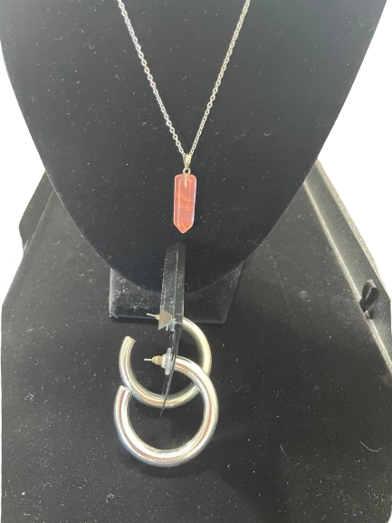 Necklace with a pendant on a black stand