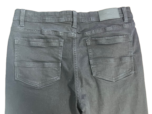 Close-up of back of jeans showing reinforced pocket stitching and Kenneth Cole logo tab.