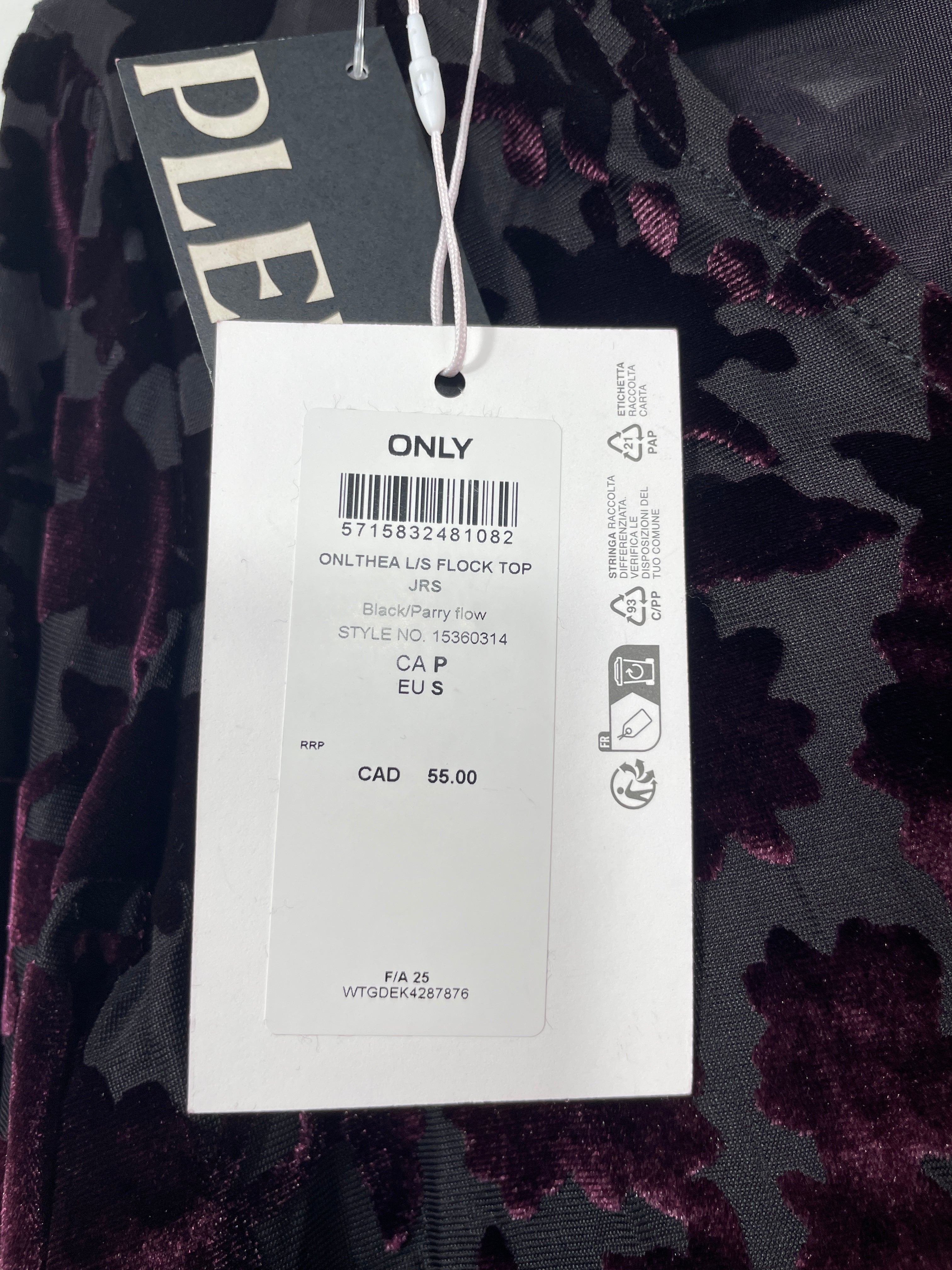 Clothing tag with brand name on a dark floral background