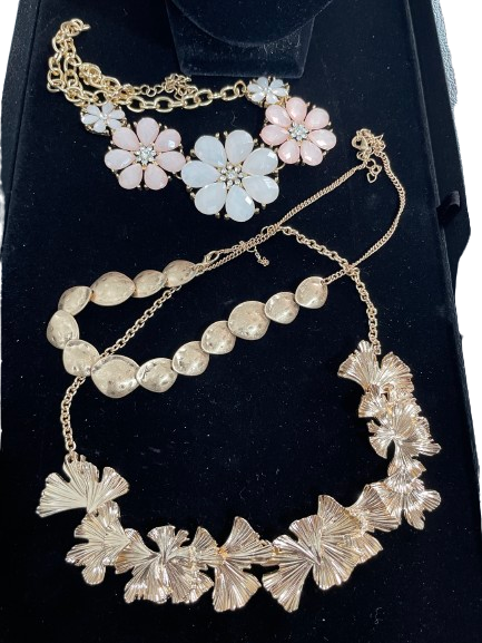 Gold tone costume necklace lot with pink floral and textured statement necklaces