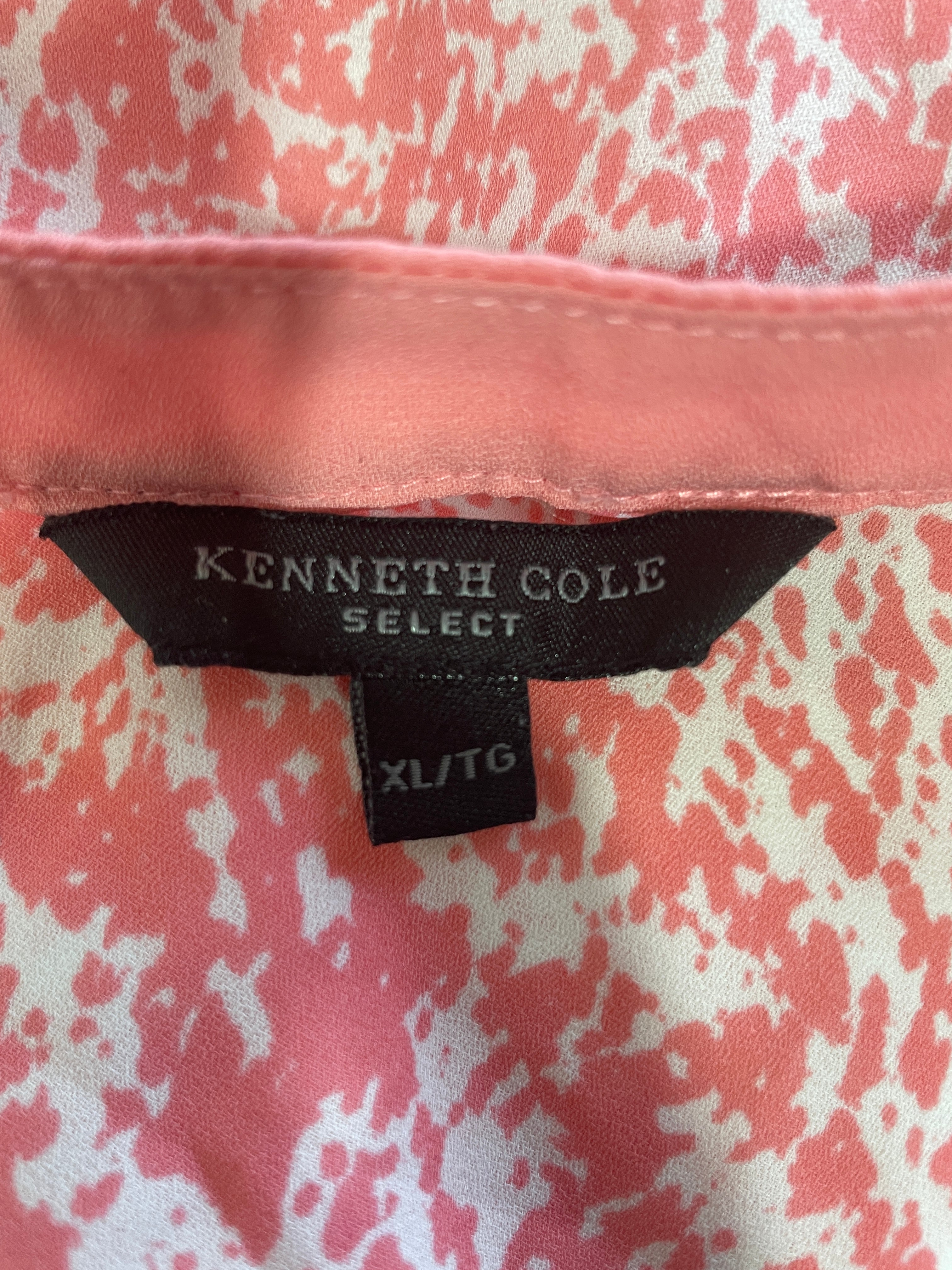 Close-up of a Kenneth Cole Select garment label on a pink and white patterned fabric, with a solid pink inner collar visible above.